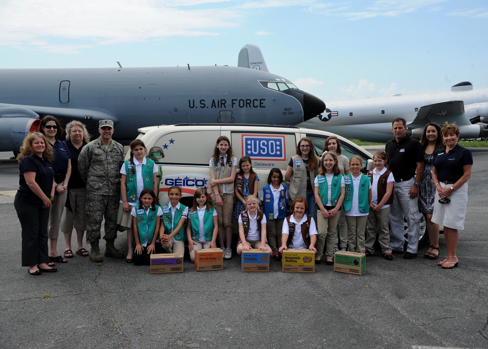 Girl Scouts and leaders from throughout the Delmarva Peninsula, members of United Services Organization Delaware and 436th Airlift Wing representatives pose for a photo during the annual Operation Taste of Home cookie drop May 13, 2014 at the Air Mobility Command Museum on Dover Air Force Base, Del. Since Operation Taste of Home was started 11 years ago, 112 Girl Scout councils have donated 350,000 boxes of cookies to military organizations under similar programs. (U.S. Air Force photo/Staff Sgt. Elizabeth Morris)