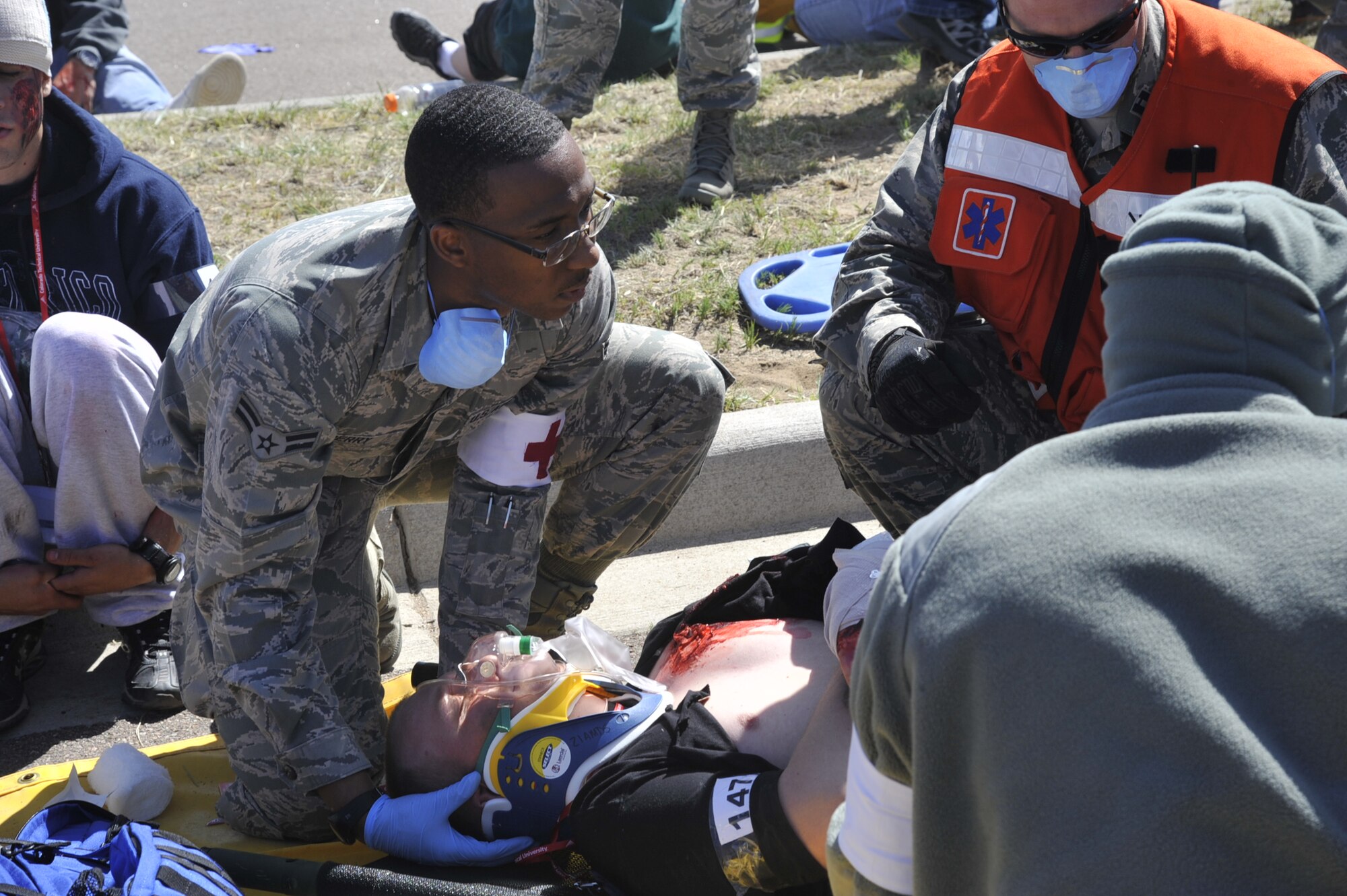 COLORADO SPRINGS, Colo. – A member of Peterson’s medical team assists in the treating of simulated patient before transport to an area hospital. The event was part of a larger emergency response exercise called SkyFall, which consisted of a massive collaboration between multiple agencies throughout the Colorado Springs region. (U.S. Air Force photo/Robb Lingley)