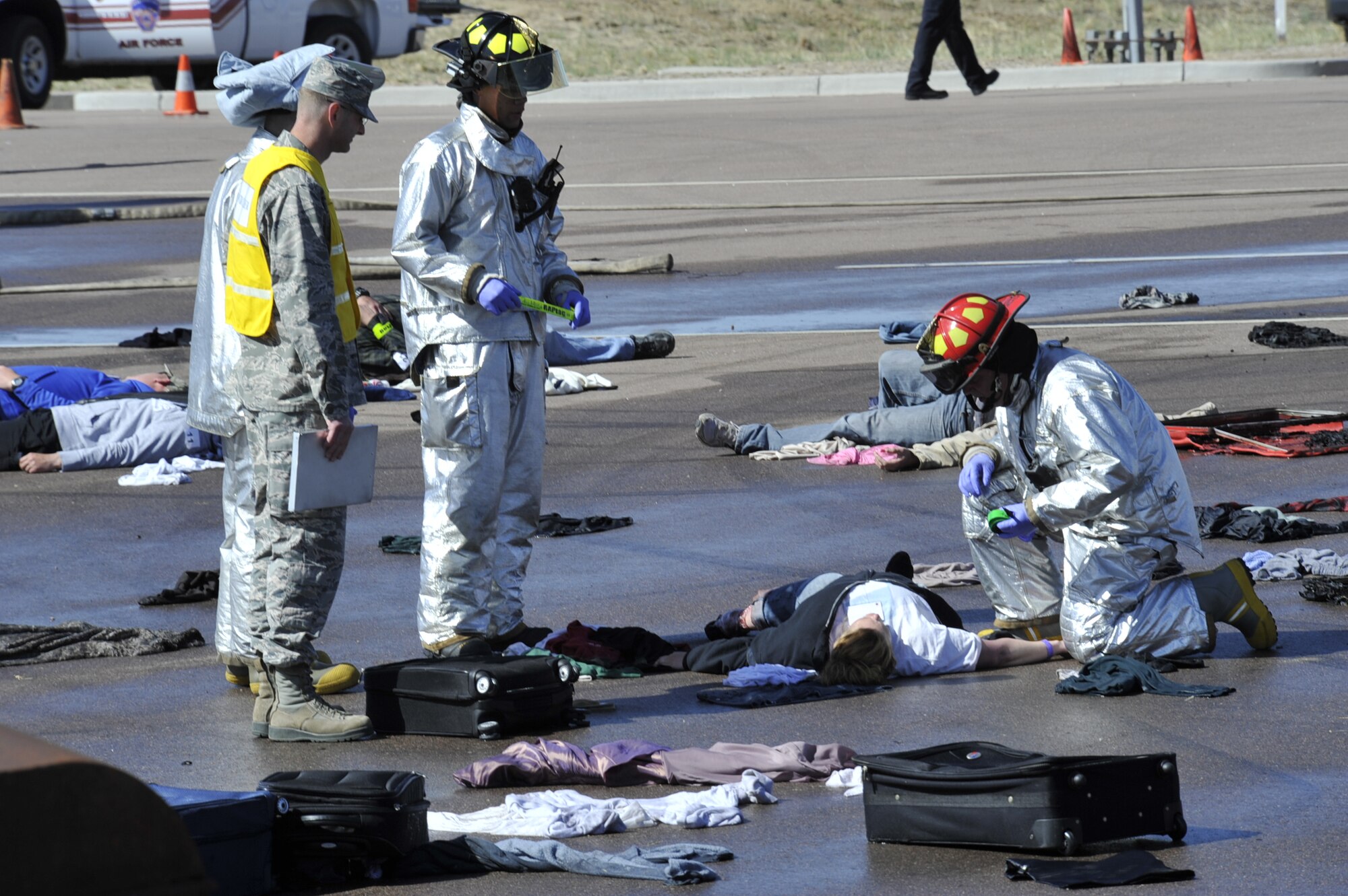 COLORADO SPRINGS, Colo. – An exercise evaluator looks on as members of the Peterson AFB crash-fire-rescue team perform on-scene medical assistance to actors simulating survivors of a plane crash. The event was part of a larger emergency response exercise called SkyFall, which consisted of a massive collaboration between multiple agencies throughout the Colorado Springs region. (U.S. Air Force photo/Robb Lingley)