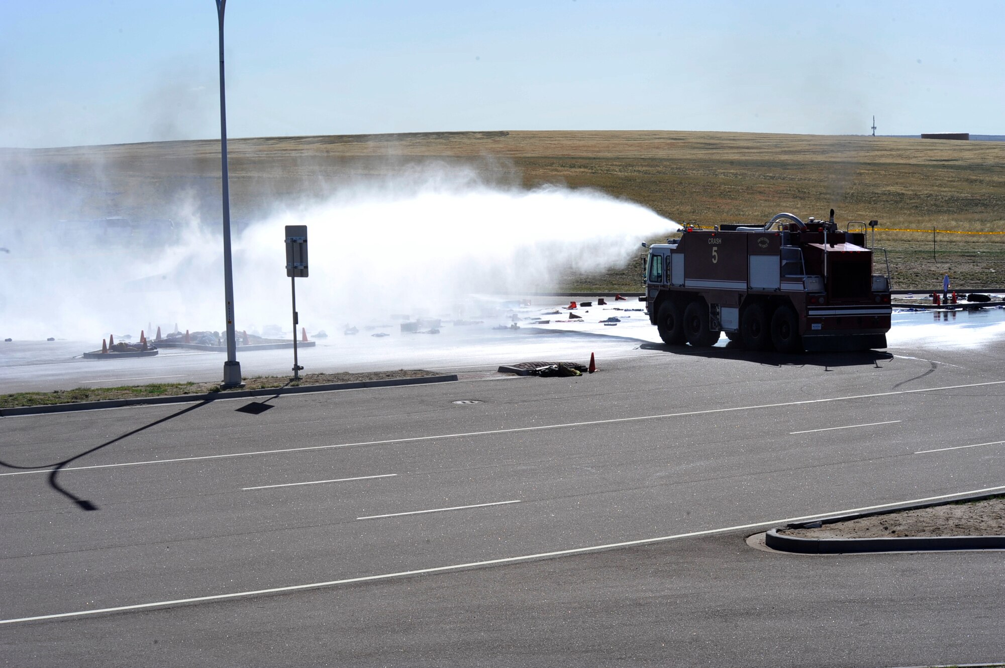 COLORADO SPRINGS, Colo. – Members of the Peterson AFB crash-fire-rescue team dowses the scene of a simulated airplane crash May 8 at the airport. The exercise was part of a larger emergency response exercise called SkyFall, which consisted of a massive collaboration between multiple agencies throughout the Colorado Springs region. (U.S. Air Force photo/Robb Lingley)