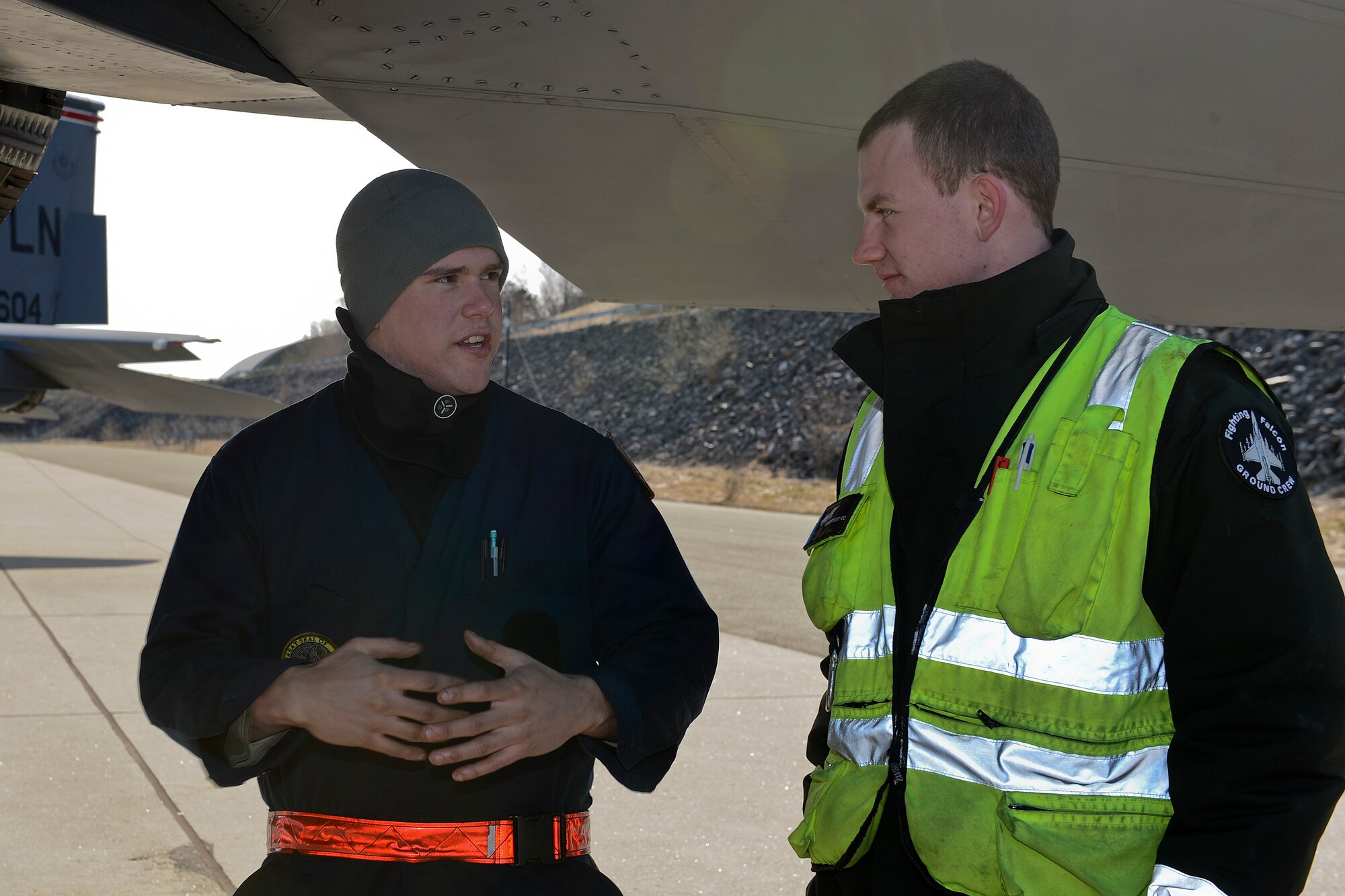 U.S. Air Force Airman 1st Class Collin Terry (left), 494th Aircraft Maintenance Unit crew chief, talks with a Norwegian air force maintainer under an F-15E Strike Eagle at Bodø Main Air Station, Norway, May 7, 2014. The maintenance teams explained how each nation maintains their aircraft at the recent Nordic Defense Cooperation exercise. (U.S. Air Force photo by Airman 1st Class Trevor T. McBride/Released) 
