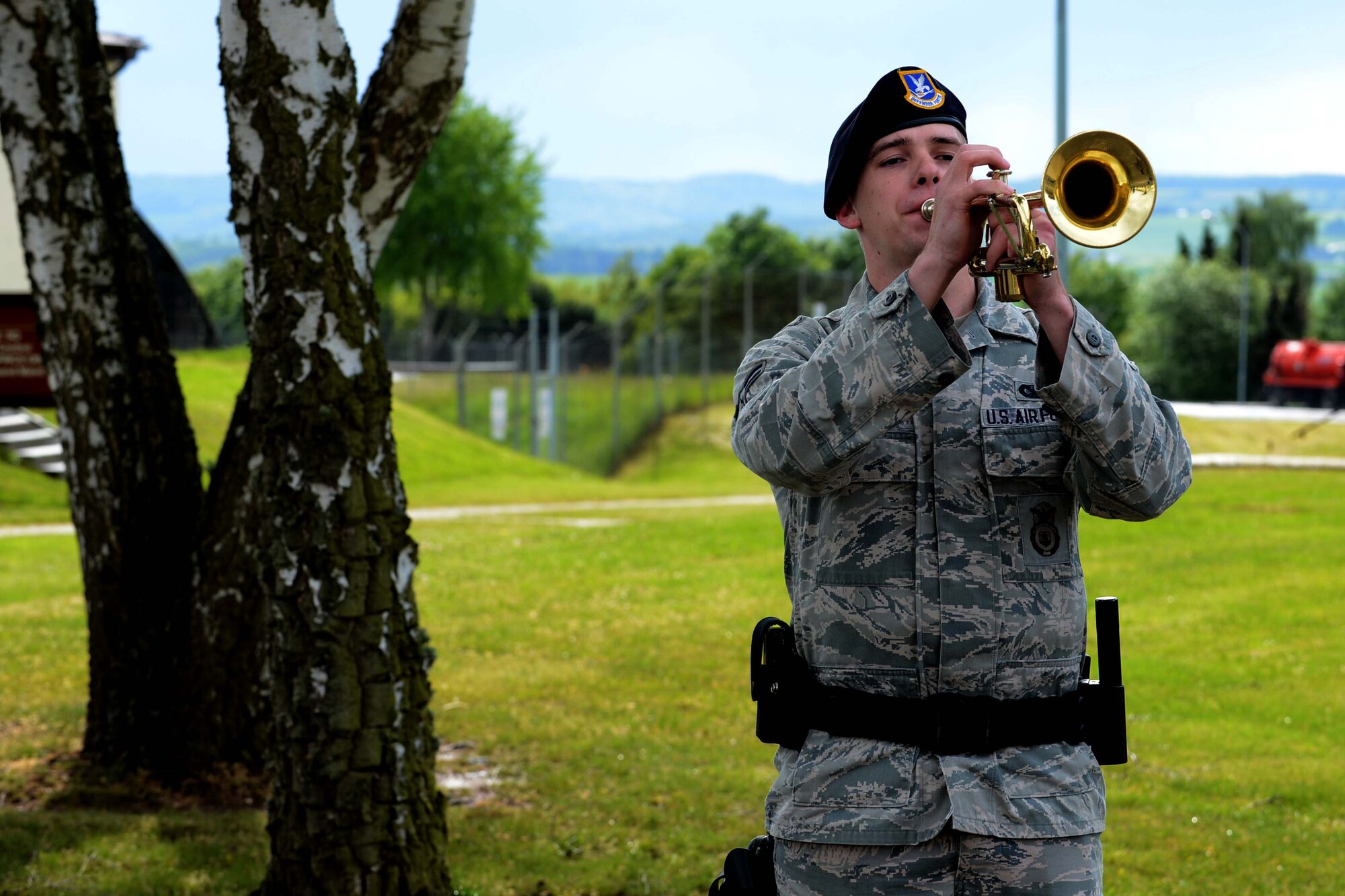 U.S. Air Force Airman 1st Class Dyllan Lewis, 52nd Security Forces Squadron entry controller, plays taps during a National Police Week retreat ceremony at Spangdahlem Air Base, Germany, May 12, 2014. The other bases events included a ruck march, jail and bail, defender decathlon and a security forces display. (U.S. Air Force photo by Airman 1st Class Kyle Gese/Released)