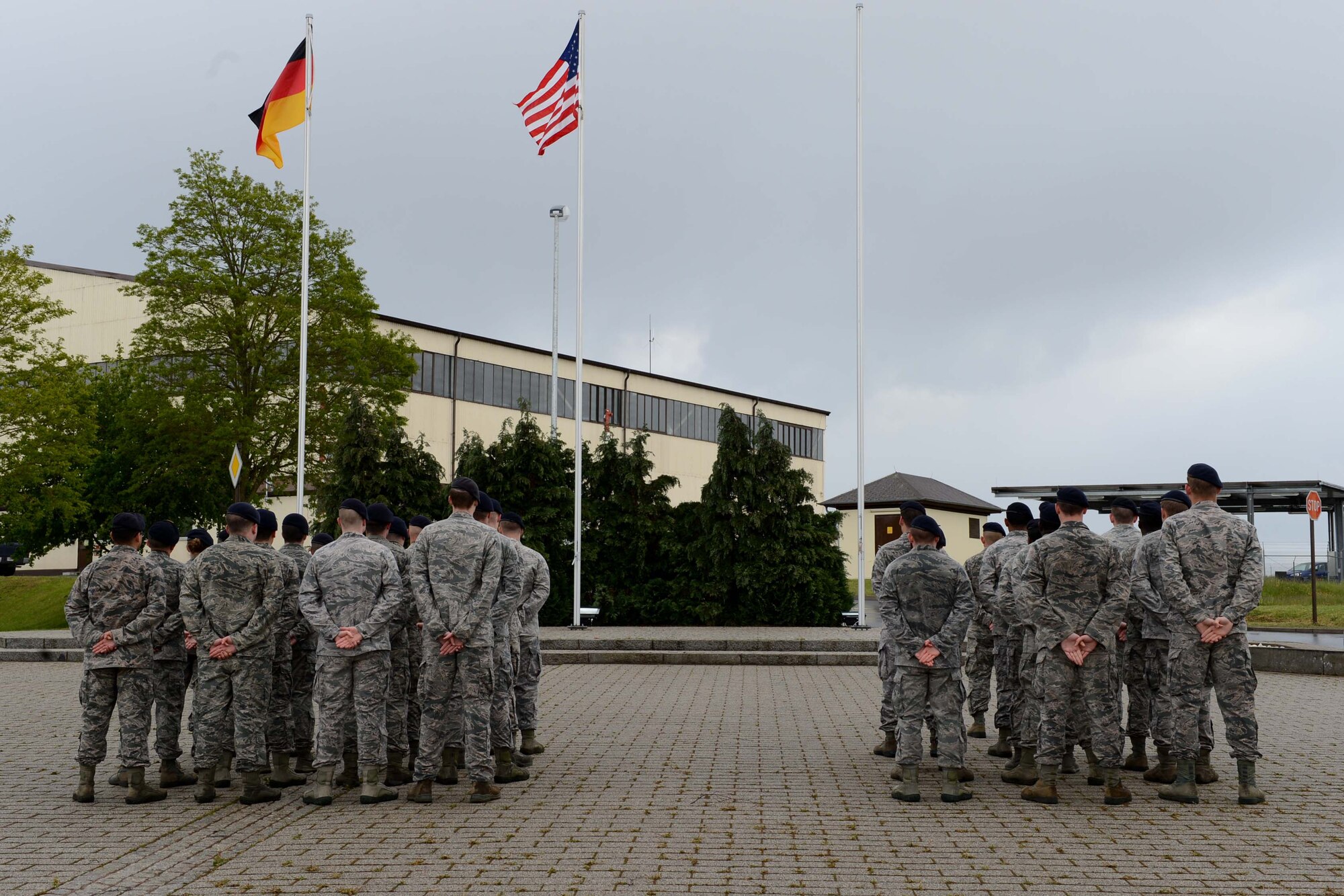 U.S. Air Force Airmen stand at parade rest during a National Police Week retreat ceremony at Spangdahlem Air Base, Germany, May 12, 2014. National Police Week is held in remembrance of fallen police officers and security forces members. (U.S. Air Force photo by Airman 1st Class Kyle Gese/Released)