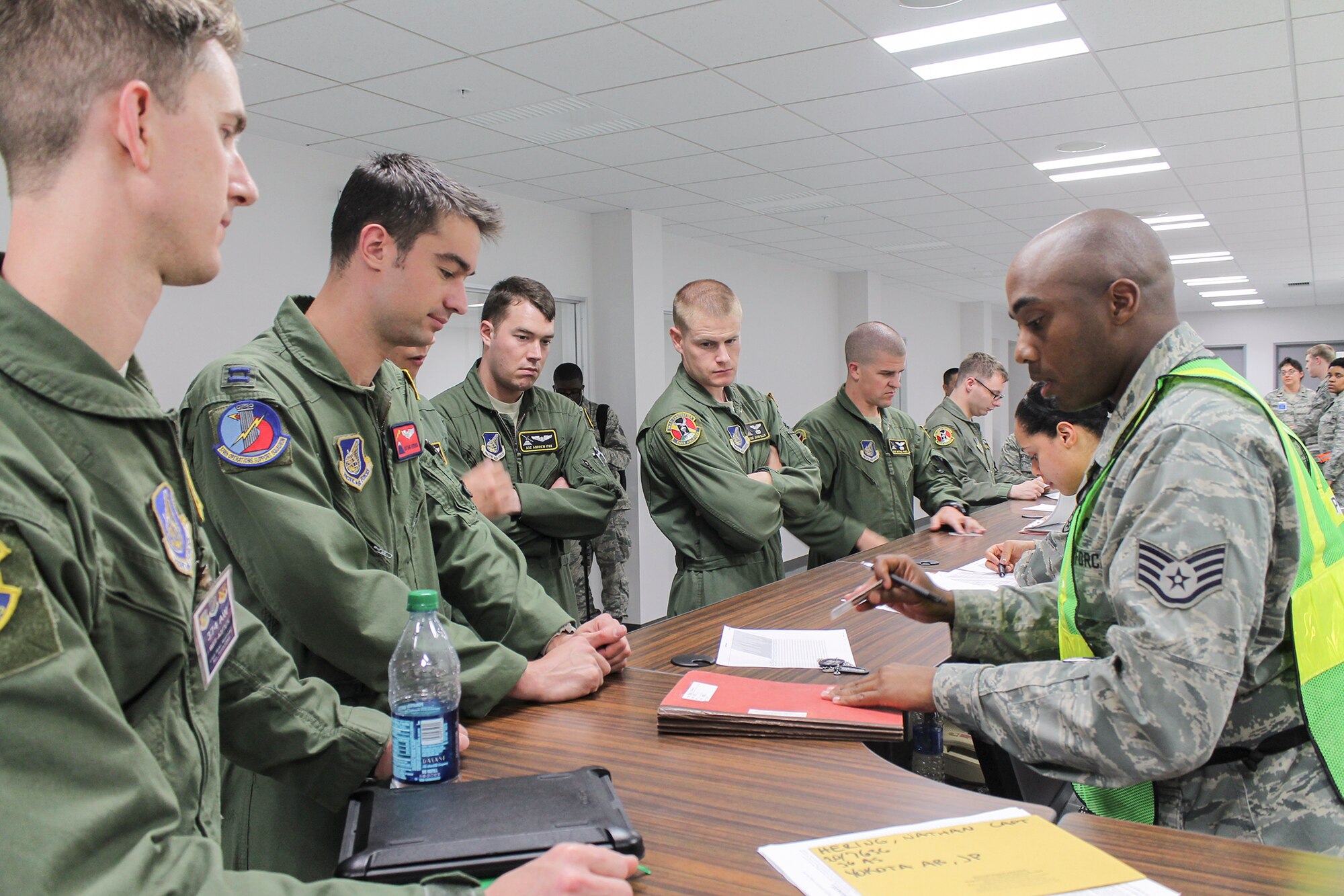 Airmen from the 36th Airlift Squadron process through an exercise deployment line during a Samurai Readiness Inspection at Yokota Air Base, Japan, May 13, 2014. Yokota Airmen exercised their ability to adapt, plan and mobilize in response to a variety of different contingencies. (U.S. Air Force photo by Airman 1st Class David Danford/Released)