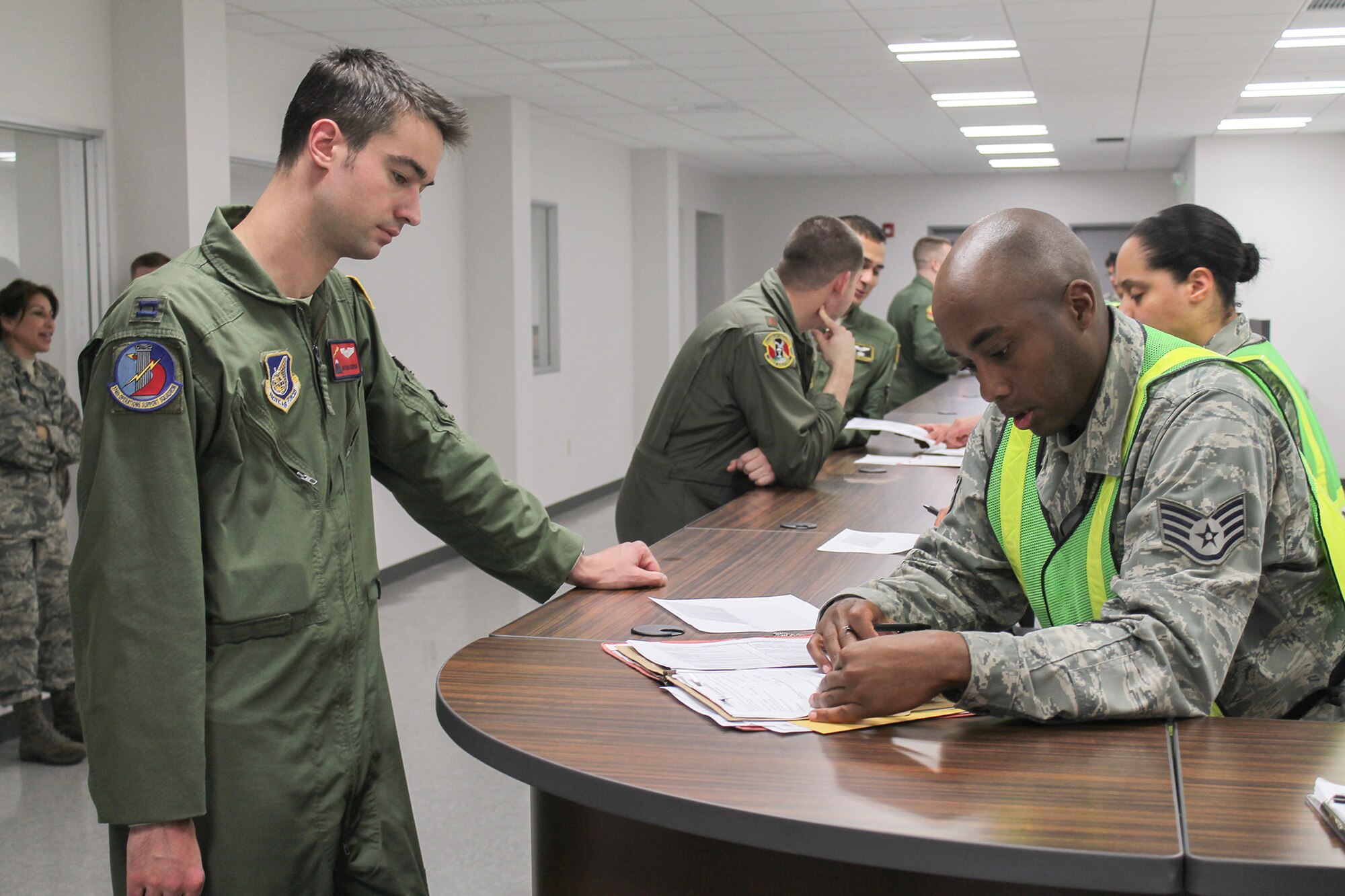 Airmen from the 36th Airlift Squadron process through an exercise deployment line during a Samurai Readiness Inspection at Yokota Air Base, Japan, May 13, 2014. As the Western Pacific Airlift Hub, Yokota regularly conducts training events designed to evaluate and improve the base's ability to deploy forces in support of regional contingencies. (U.S. Air Force photo by Airman 1st Class David Danford/Released)