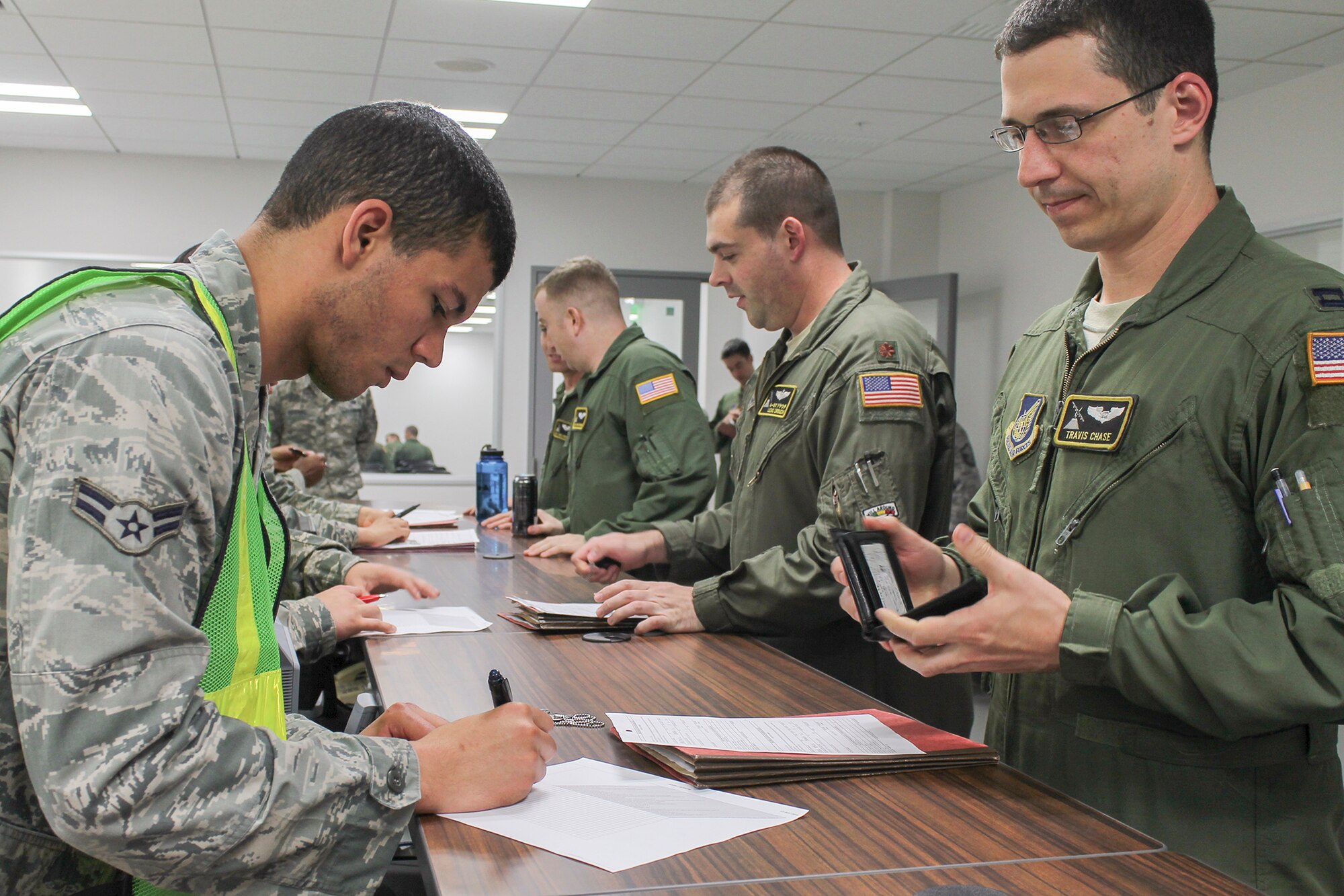 Airmen from the 36th Airlift Squadron process through an exercise deployment line during a Samurai Readiness Inspection at Yokota Air Base, Japan, May 13, 2014. The inspection tested Yokota's ability to mobilize forces in response to a simulated natural disaster. (U.S. Air Force photo by Airman 1st Class David Danford/Released)