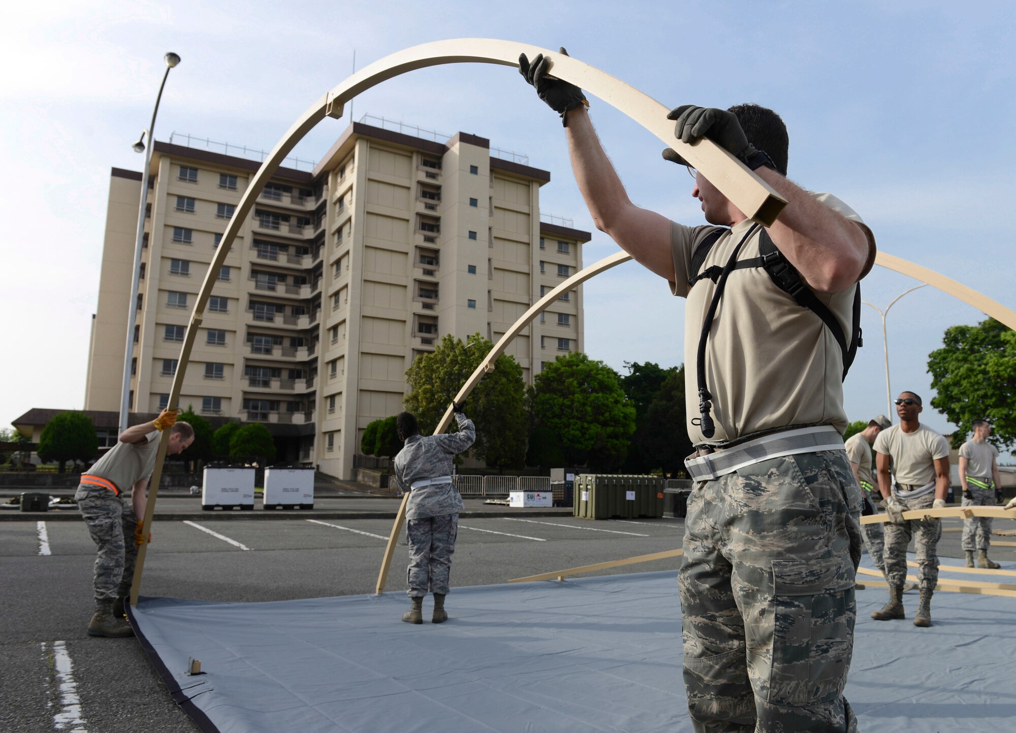 Metal beams are grounded to make an Expeditionary Medical Support tent at Yokota Air Base, Japan, May 14, 2014.  Airmen from the 374th Medical Group tested their abilities to set-up a EMEDS tent during a Samurai Readiness Inspection. (U.S. Air Force photo by Airman 1st Class Meagan Schutter/Released)