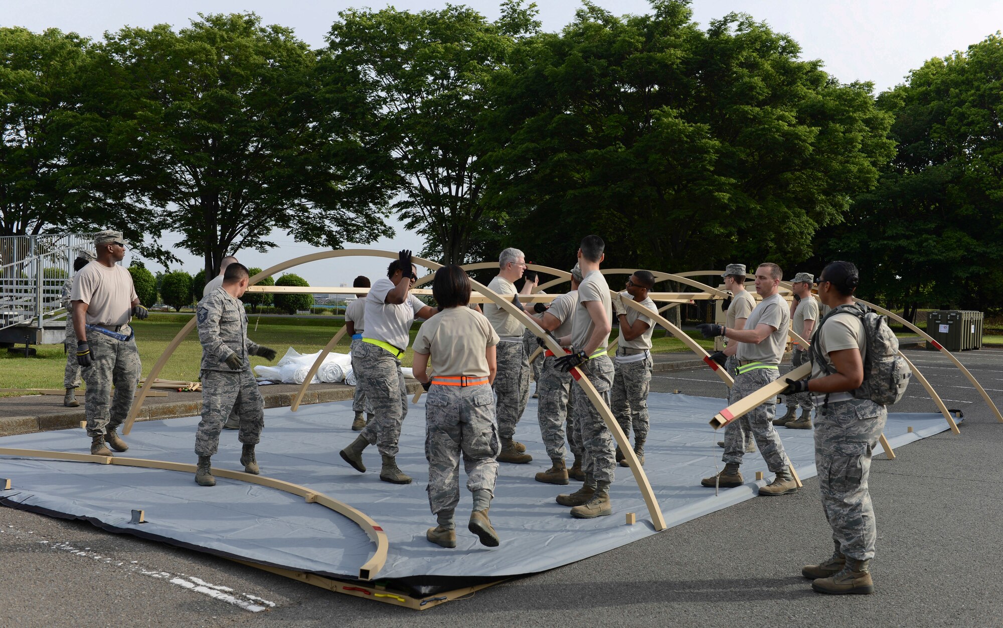 Airmen from the 374th Medical Group assemble an Expeditionary Medical Support tent at Yokota Air Base, Japan, May 14, 2014.  An EMEDS tent allows medical personnel to treat patients during a contingency. (U.S. Air Force photo by Airman 1st Class Meagan Schutter/Released)
