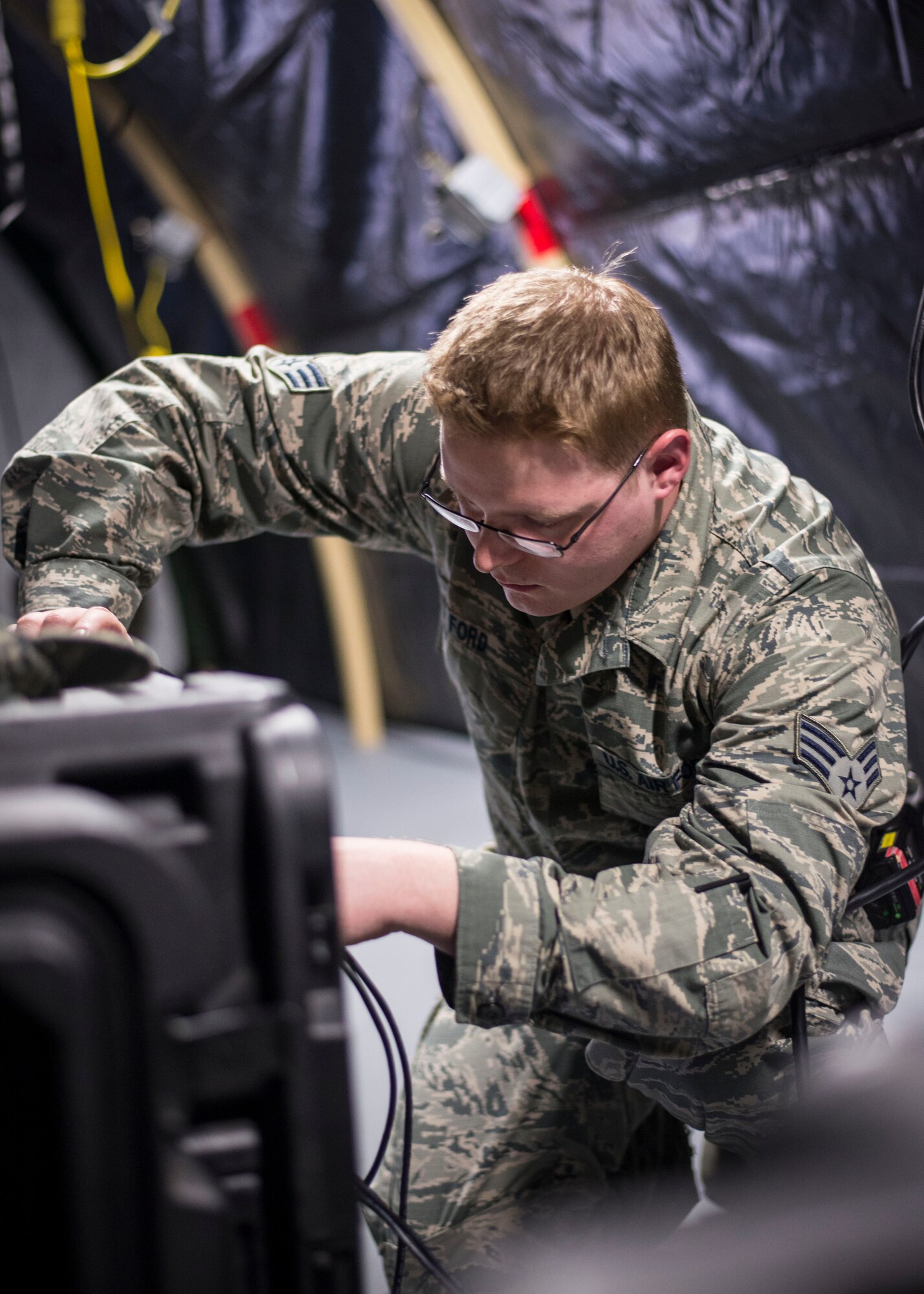 Senior Airman Melvin Ford, 374th Medical Support Squadron information technology technician, works on a deployable Theater Medical Information Program server during a Samurai Readiness Inspection at Yokota Air Base, Japan, May 14, 2014. The MDSS team practiced their Expeditionary Medical Support capability to better prepare themselves for contingency medical responses. (U.S. Air Force Photo by Capt. Raymond Geoffroy)