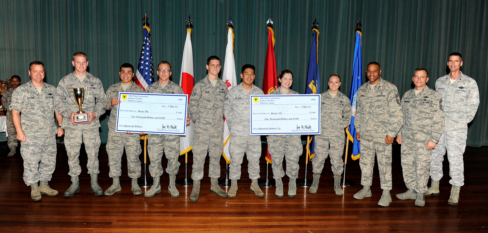 U.S. Air Force Dorms 145 and 700 council members are presented the Dorms of the Quarter Awards during the Team Kadena first quarter awards ceremony on Kadena Air Base, Japan, May 9, 2014. For quality of life improvements to the dorms, Dorm 700 was given a $2,000 prize for winning first place, and Dorm 145 was given $1,000. (U.S. Air Force photo by Senior Airman Maeson L. Elleman)