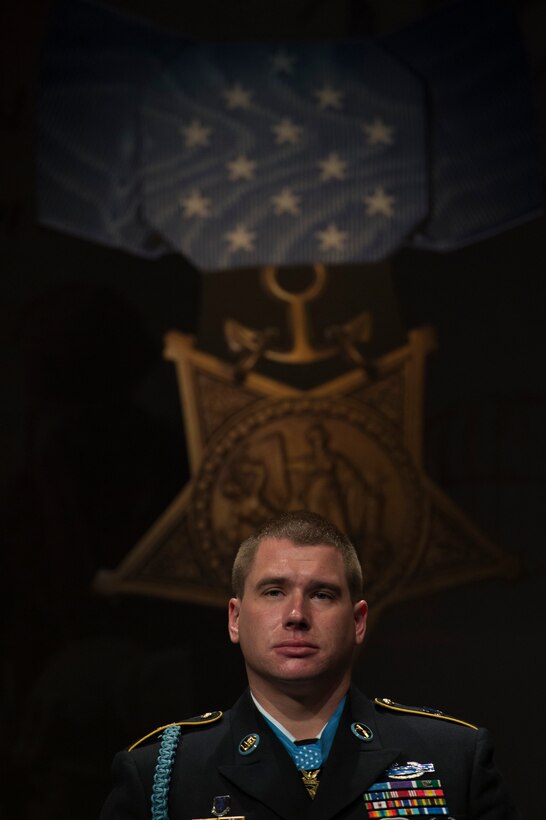 Former Army Sgt. Kyle J. White stands at attention during a ceremony to induct him into the Hall of Heroes at the Pentagon, May 14, 2014.