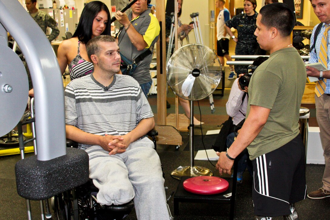 Marine Corps Sgt. Luis Remache, right, offers words of encouragement to Boston Marathon bombing victim J.P. Norden during his visit to the Walter Reed National Military Medical Center in Bethesda, Md., June 12, 2013. Norden and his brother, Paul Norden, each lost a leg, and were pelted with shrapnel during the second blast at the April 15 marathon while shielding others from the first blast.  

