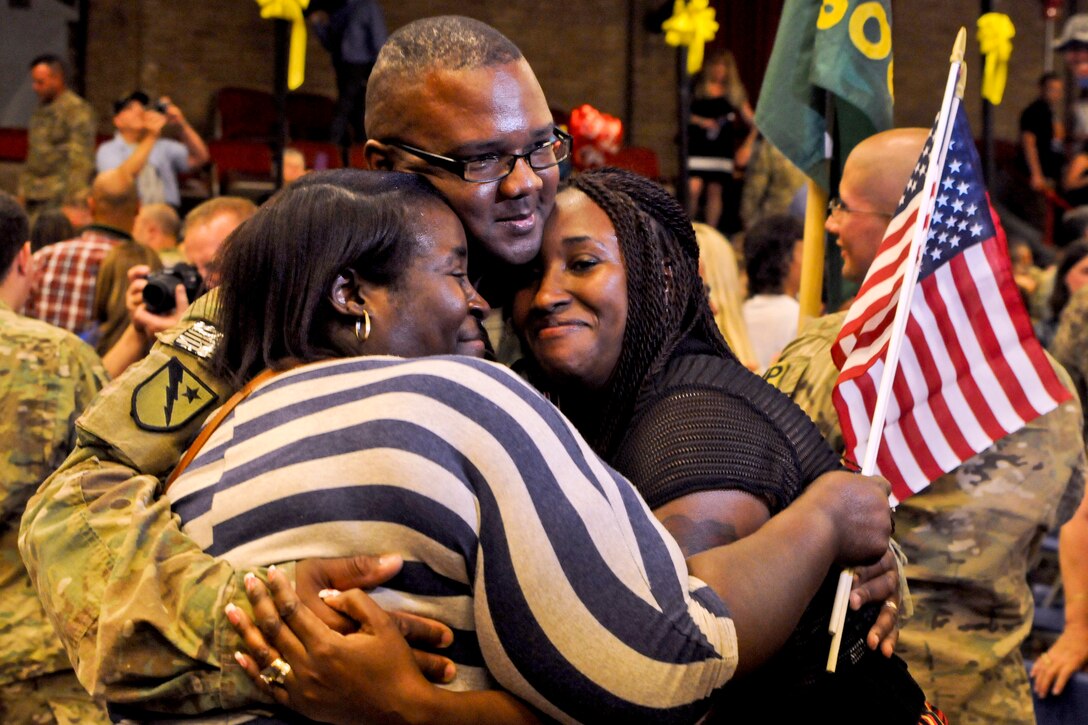 Army Staff Sgt. Samuel Spencer III receives an embrace from his family after returning from a nine-month deployment to Afghanistan at the Lawrenceville Armory in Trenton, N.J., June 6, 2013, Spencer was assigned to the 508th Military Police Company, which provided security and force protection, and advised the Afghan national police force in the Kabul region.  
