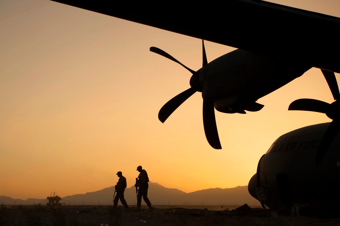 U.S. Air Force Airman 1st Class Christian Mejia and U.S. Air Force Staff Sgt. Duron Arnold perform a security check around a disabled C-130 Hercules aircraft on Forward Operating Base Shank in Afghanistan's Logar province, June 6, 2013. Mejia and Duron, assigned to the 376th Expeditionary Security Forces Squadron Fly Away Security Team, are forward deployed from Manas Air Base, Kyrgyzstan.  
