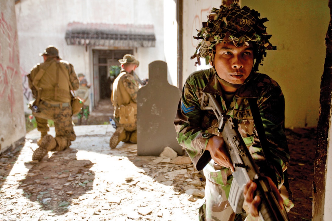 An Indonesian marine conducts military operations in urban terrain training with U.S. Marines during Cooperation Afloat Readiness and Training 2013, known as CARAT, in Antralina, Indonesia, May 26, 2013. More than 1,000 sailors and Marines are participating in CARAT Indonesia 2013 -- a series of bilateral military exercises involving the U.S. Navy, U.S. Marine Corps and the armed forces of Bangladesh, Brunei, Cambodia, Indonesia, Malaysia, the Philippines, Singapore and Thailand.  
