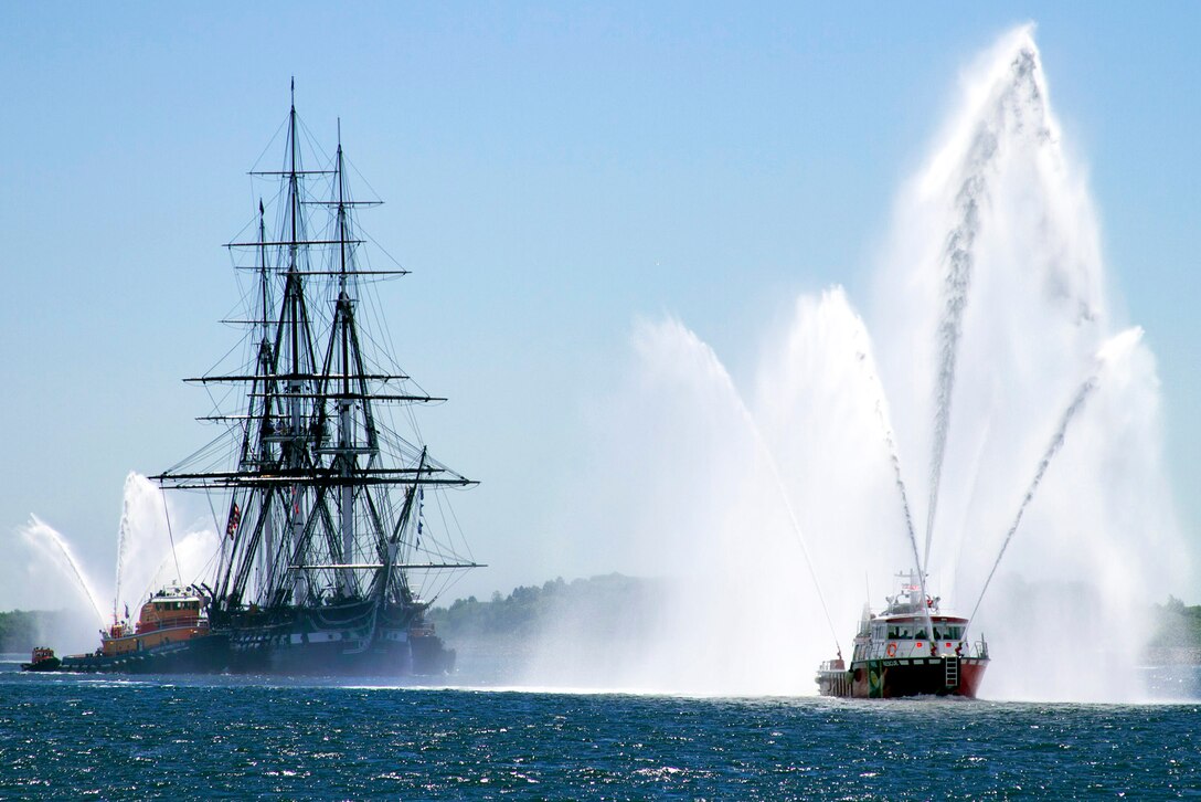 A Massport Fire Rescue boat escorts the USS Constitution during her first turnaround cruise of 2013, Boston, Mass., June 4, 2013. The cruise commemorated the 71st anniversary of the Battle of Midway and recognized first responders of the Boston Marathon bombings.  
