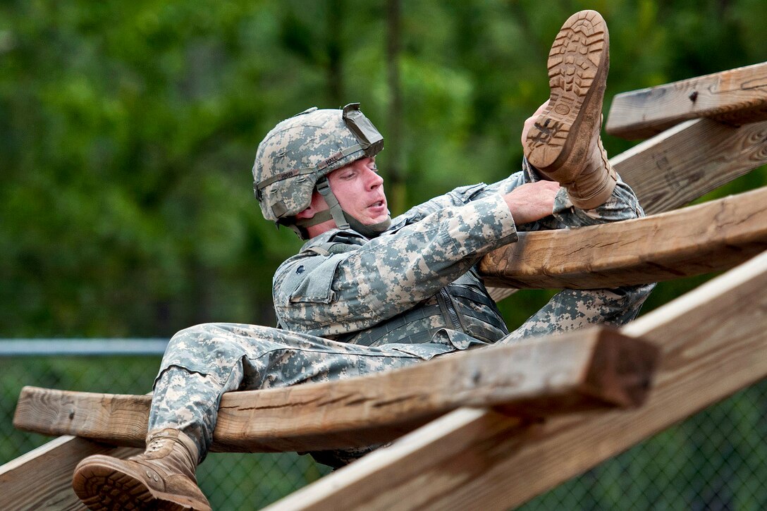 A paratrooper weaves through a ladder obstacle while competing in a team assault obstacle course competition that is part of the 82nd Airborne Division's All-American week celebration on Fort Bragg, N.C., May 21, 2013.  
