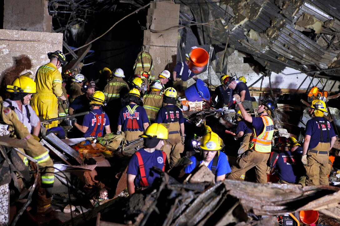 Oklahoma National Guard soldiers, airmen, civilian firefighters and policemen search for survivors through the rubble of a building that was devastated by a tornado that killed dozens of people in Moore, Okla., May 20, 2013. The guardsmen are assigned to the 700th Brigade Support Battalion, 45th Infantry Brigade Combat Team and 146th Air Support Operations Squadron.  
