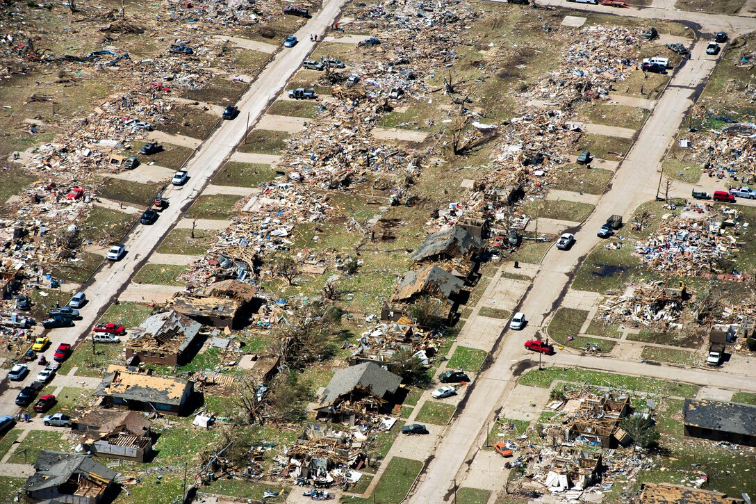 Oklahoma National Guardsmen fly over tornado destruction in Moore, Okla., May, 22, 2013. 
