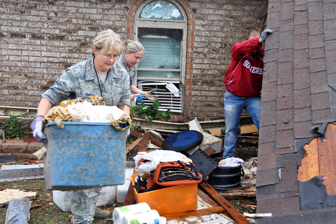 Air Force Master Sgt. Cherry Bina recovers personal items from her own house in Moore, Okla., May 21, 2013. Her house was severely damaged after a devastating tornado killed dozens of people there, May 20. Bina is assigned to the Oklahoma Air National Guard’s 137th Maintenance Group.  
