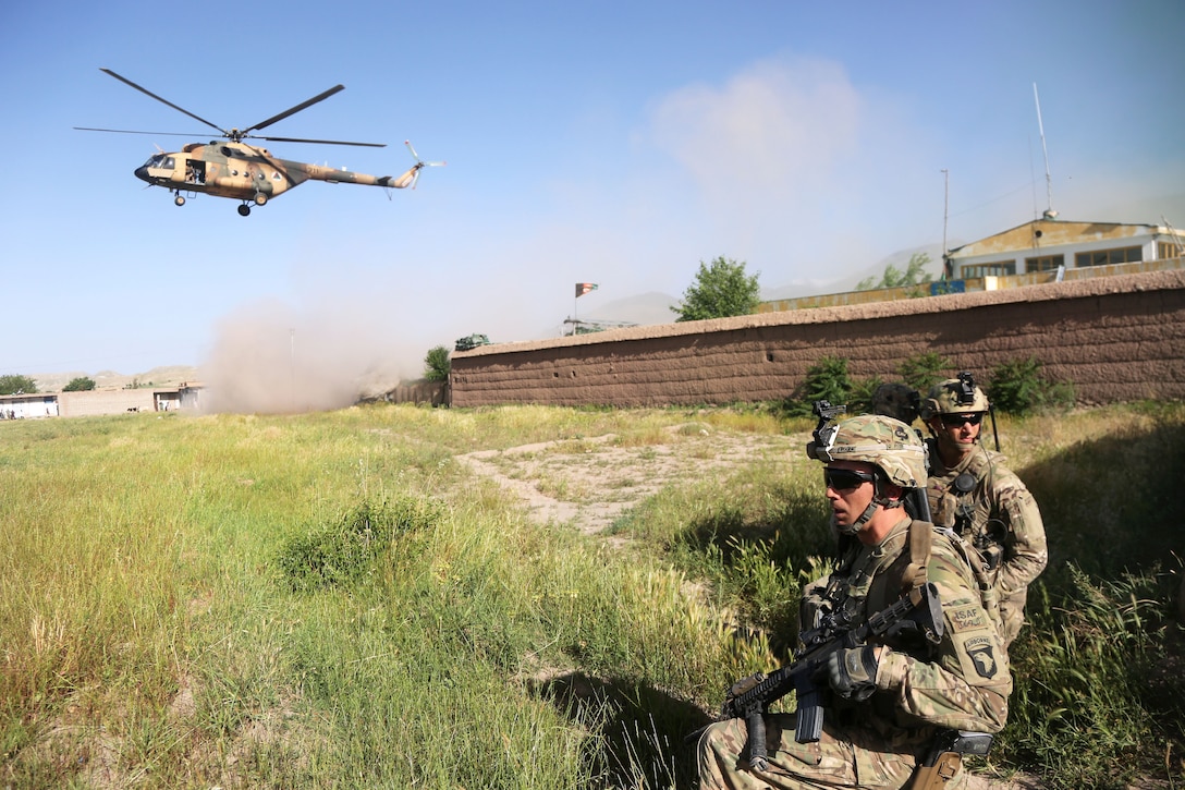 U.S. soldiers secure a landing zone for an Afghan air force Mi-17 helicopter outside of Hesarak village in Nangarhar province, Afghanistan, May 17, 2013. The soldiers are assigned to the 101st Airborne Division's Company A, 1st Battalion, 327th Infantry Regiment, 1st Brigade Combat Team.  
