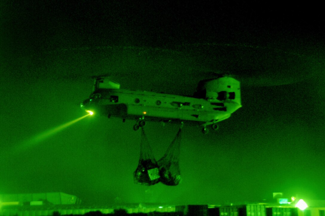 As seen through a night-vision device, U.S. soldiers work with CH-47 Chinook helicopter crews during a sling-load operation on Jalalabad Airfield in Nangarhar province, Afghanistan, May 10, 2013. The helicopter crews are assigned to the 101st Airborne Division's 101st Combat Aviation Brigade, and the soldiers are assigned to the 101st Airborne Division's 426th Brigade Support Battalion, 1st Brigade Combat Team.  
