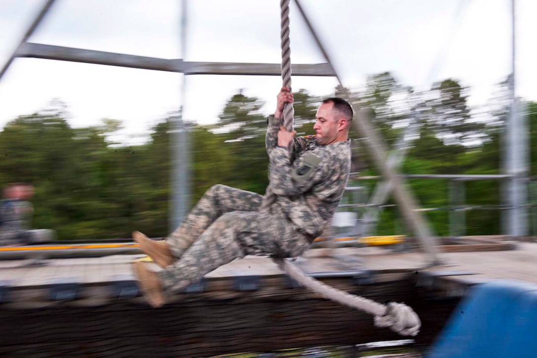 Army Staff Sgt. Jesse Mullinax swings across a pit during the Region 3 Best Warrior Competition at McCrady Training Center on Fort Jackson, S.C., May 1, 2013. Soldiers from 10 states and territories compete over four days for a place in the Army's Best Warrior Competition. Mullinax is assigned to the 218th Regiment, South Carolina Army National Guard.  
