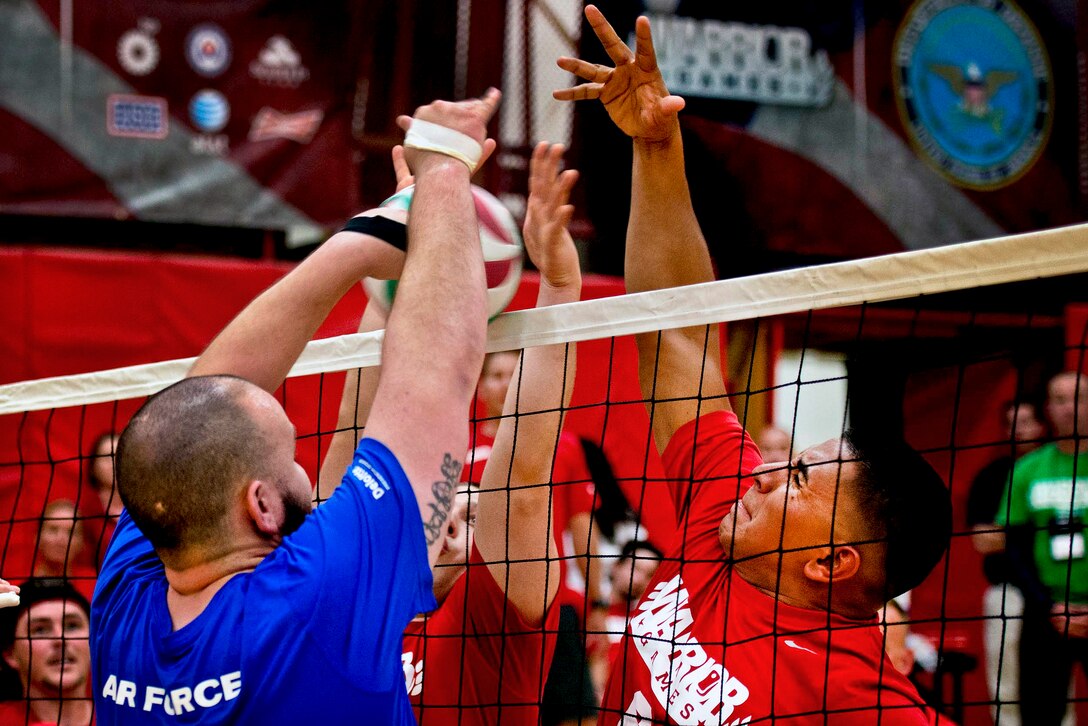 U.S. Marine Corps photo by Sgt. Tyler L. Main  
Caption: Marine Corps and Air Force players fight for a point during the 2013 Warrior Games in Colorado Springs, Colo., May 13, 2013. The Marines beat the Air Force in two sets to remain undefeated. 
