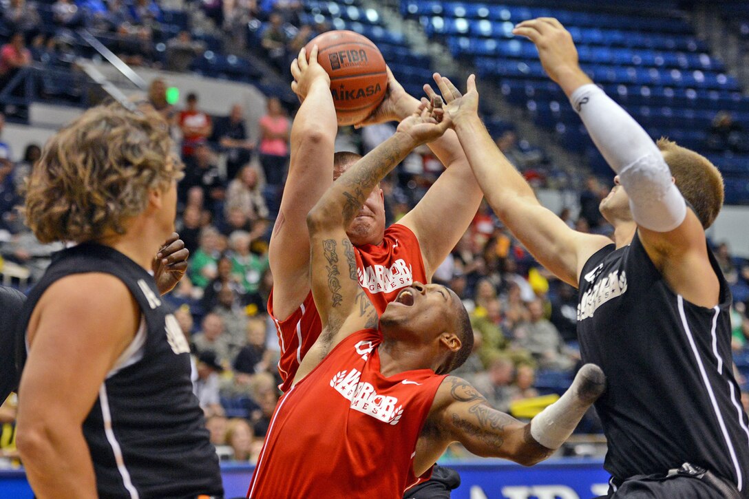Army basketball players battle for a rebound during the 2013 Warrior Games gold medal wheelchair basketball match in Colorado Springs, Colo., May 15, 2013.  
