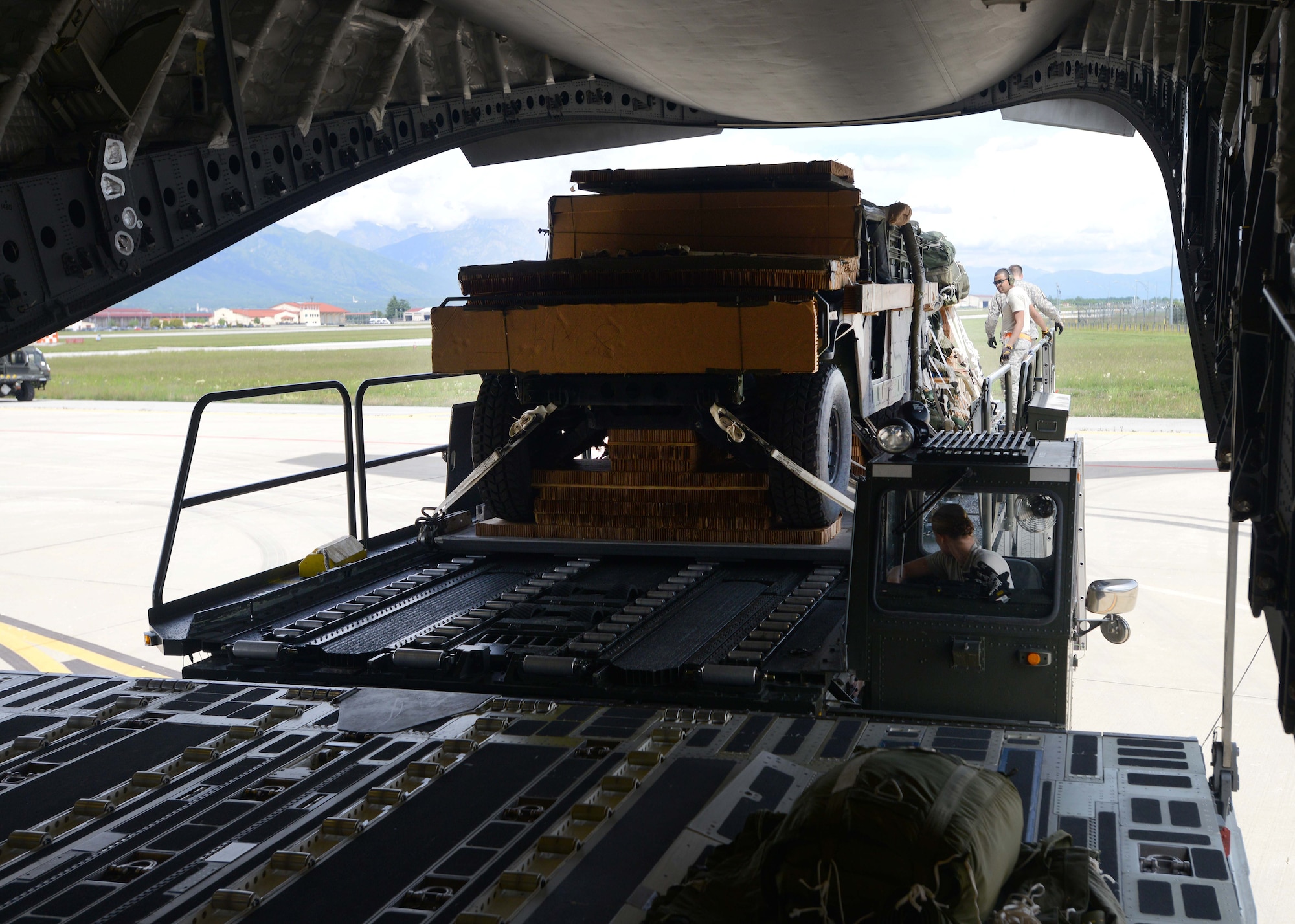 Aircraft services technicians from the 724th Air Mobility Squadron load a Humvee onto a C-17 Globemaster III, May 12, 2014, at Aviano Air Base, Italy. The Aviano Airmen assisted in loading cargo and U.S. Army paratroopers onto the aircraft in support of U.S. Army Europe’s Land Forces Assurance Exercises.  (U.S. Air Force photo/Airman 1st Class Deana Heitzman)