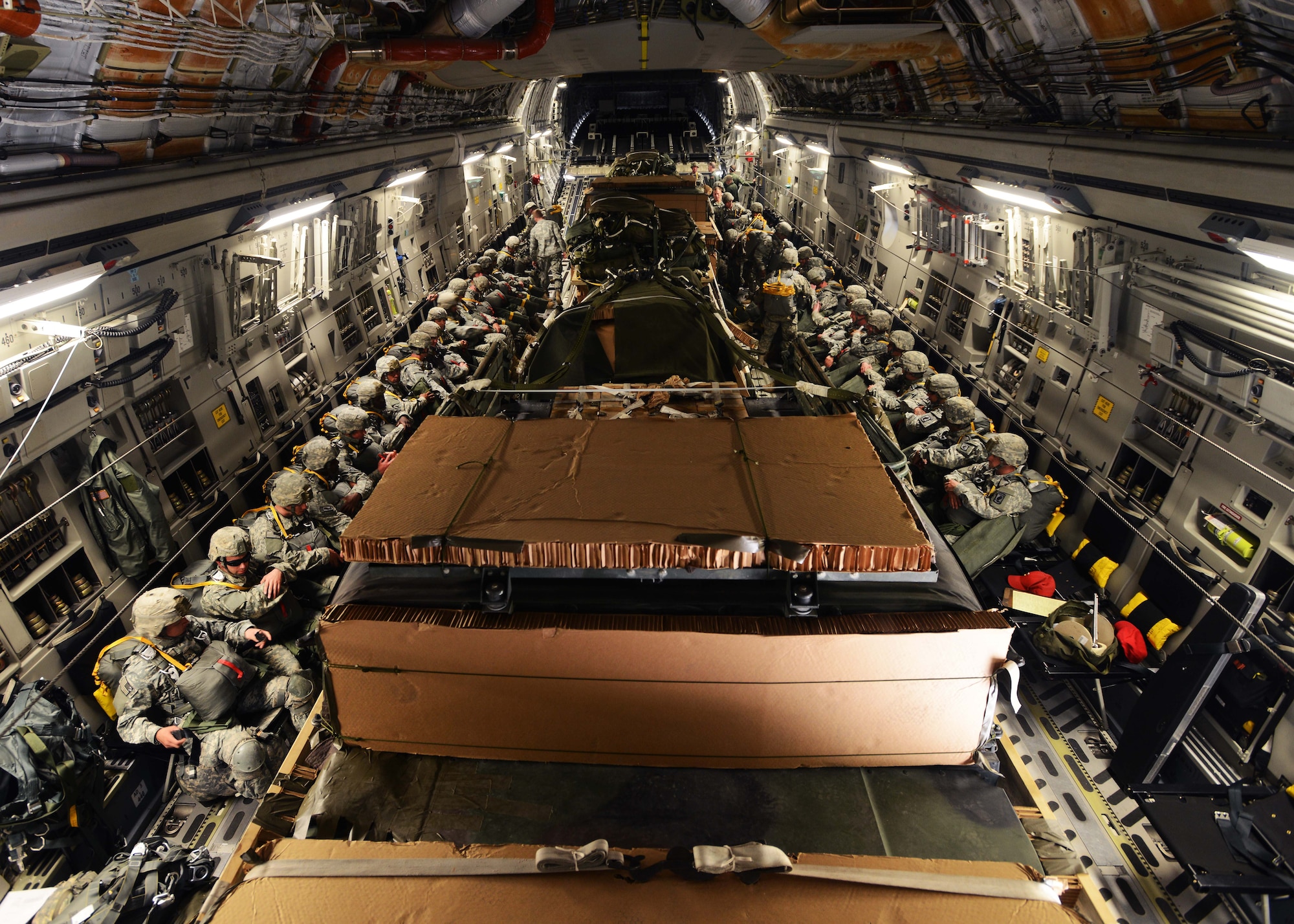 A platoon of approximately 30 airborne field artillery paratroopers from Bravo Battery, 4th Battalion, 319th Airborne Field Artillery Regiment, wait to depart from Aviano Air Base, Italy, May 12, 2014, on a C-17 Globemaster III. The platoon deployed to Poland in support of U.S. Army Europe’s Land Forces Assurance exercises. (U.S. Air Force photo/Airman 1st Class Deana Heitzman)