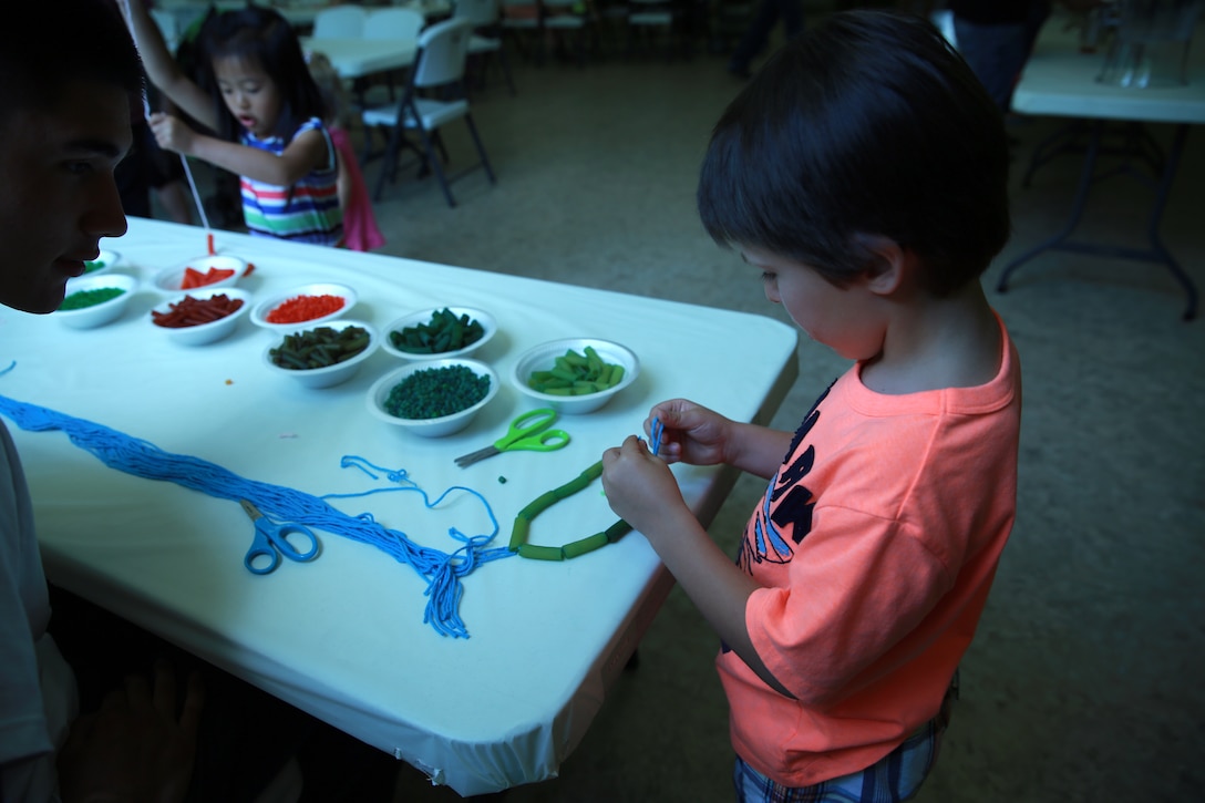 Children make macaroni necklaces and bracelets during the Mother’s Day Tea at the Tarawa Terrace Community Center aboard Marine Corps Base Camp Lejeune, May 10. The event was designed to give mothers a chance to relax and play with their children while being honored for their contribution to their families. 