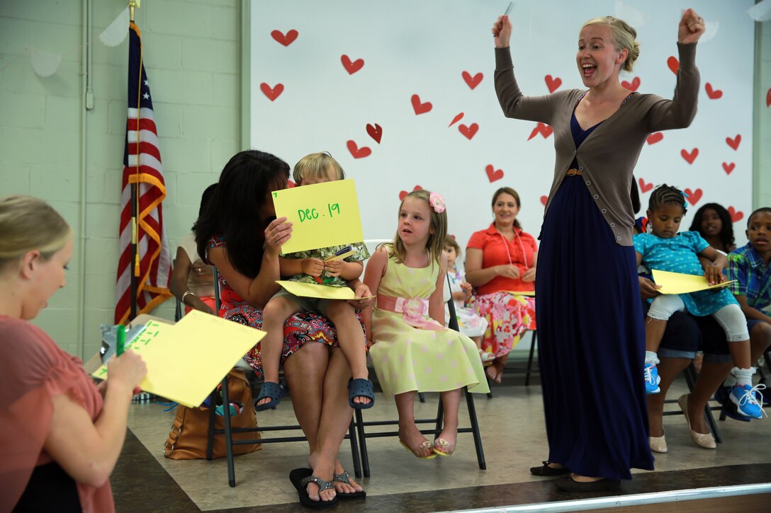 Gabrielle Parish, a recreation specialist with the Tarawa Terrace Community Center, cheers on participants during the Mother’s Day Tea at the Tarawa Terrace Community Center aboard Marine Corps Base Camp Lejeune, May 10. The event was designed to give mothers a chance to relax and play with their children while being honored for their contribution to their families. 

