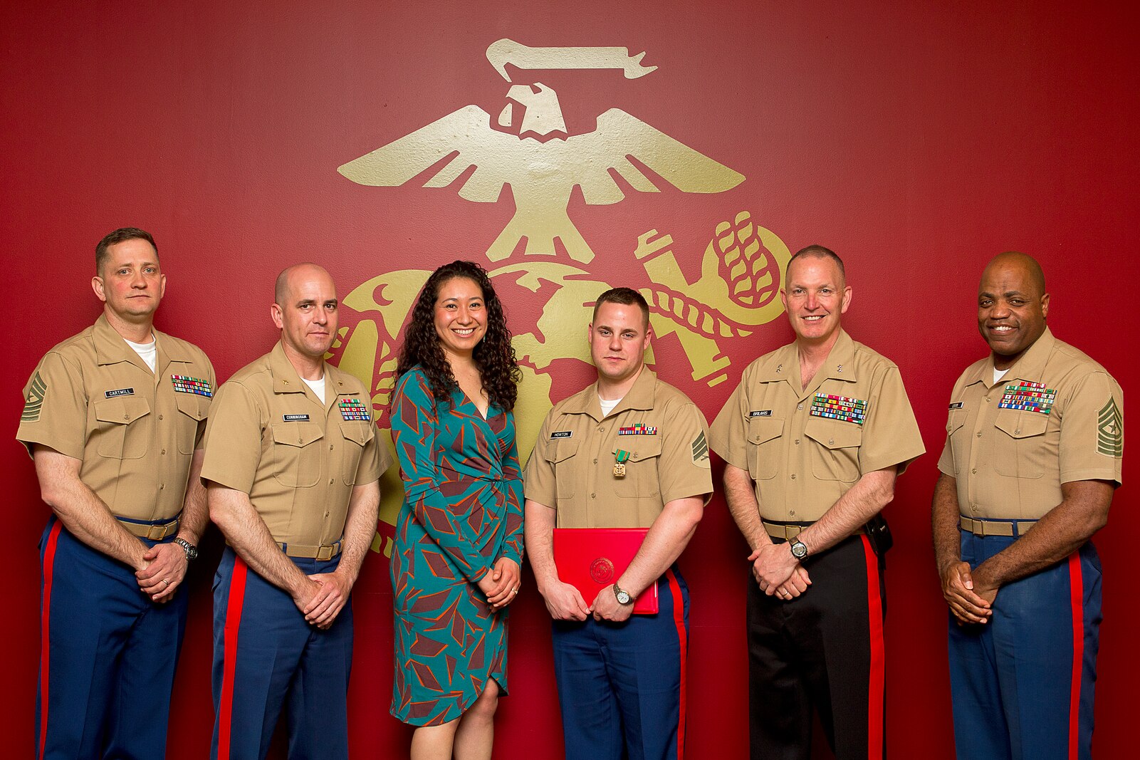 Sgt. Jason Howton (fourth from left), a recruiter assigned to Marine Corps Permanent Contact Station Port Angeles, Wash., poses with his wife and command members of Marine Corps Recruiting Command and Marine Corps Recruiting Station Seattle following an awards ceremony at MCRS Seattle, April 15, 2014. During the ceremony, Howton received a Navy and Marine Corps Achievement Medal for his exceptional contribution to MCRS Seattle’s recruiting mission. Howton, 27, is from Milton, Fla.
