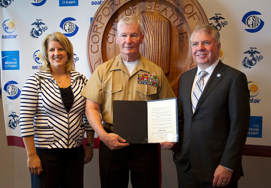 Lt. Gen. John Toolan (center), the commanding general of I Marine Expeditionary Force, displays the Marine Week Seattle proclamation with Beth Knox (left), the president of SeaFair, and Seattle Mayor Ed Murray (right) following a Marine Week Seattle press conference at Seattle City Hall, May 7, 2014. Marine Week Seattle is a community relations event that will be held in Seattle, July 26-August 3. It will provide Washingtonians an opportunity to interact and become acquainted with the Marine Corps as America’s expeditionary force in readiness. During the event, citizens will have the opportunity to view state-of-the-art static aircraft and ground equipment displays, military technology, combat weaponry and the Marine Corps Band. Marines will support community service projects and conduct a variety of demonstrations, including the Marine Corps Martial Arts Program and a simulated full-scale combat scenario. (U.S. Marine Corps photo by Sgt. Reece Lodder)