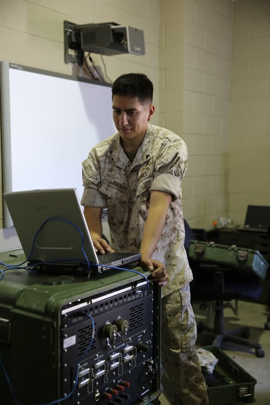 Lance Cpl. Jurando Emiliano provides communication capabilities to Marine Wing Support Squadron 271 May 13, at Marine Corps Air Station Cherry Point, N.C. Emiliano uses a Toughbook and remote subscriber access module to provide essential personnel with communications both locally and overseas. Emiliano is a field wireman with MWSSS-271.