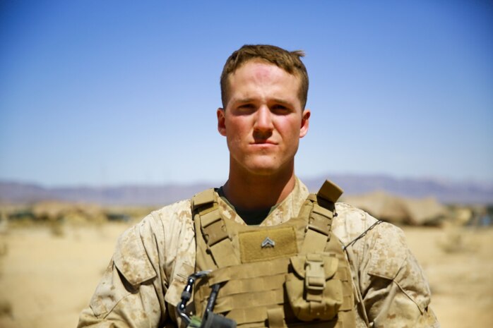 Corporal Ian Moore, a Marine Musician with Headquarters Battalion, 1st Marine Division, participates in Exercise Desert Scimitar as part of the security platoon at Marine Corps Air Ground Combat Center Twentynine Palms, Calif., May 12, 2014. Moore, a native of Roseburg, Ore., enjoys the opportunity to trade his dress blue uniform for camouflage utilities and his instrument for a rifle. The security platoon is comprised of Marines of varying jobs including band members, motor transport operators and data wire technicians. They come together to provide security for 1st Marine Division during the exercise, maintaining an entry control point and conducting patrols around the camp. (U.S. Marine Corps photograph by Sgt. Timothy Lenzo/RELEASED)