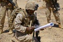 Corporal Bereket Berhane, a warehouse clerk with Headquarters Battalion, 1st Marine Division, maps out a security patrol route during Exercise Desert Scimitar at Marine Corps Air Ground Combat Center Twentynine Palms, Calif., May 12, 2014. It is not uncommon for Marines like Berhane, a native of Dallas, to be called upon to maintain security during field training. 1st Marine Division acts as the headquarters element of I Marine Expeditionary Force during the exercise. (U.S. Marine Corps photograph by Sgt. Timothy Lenzo/RELEASED)