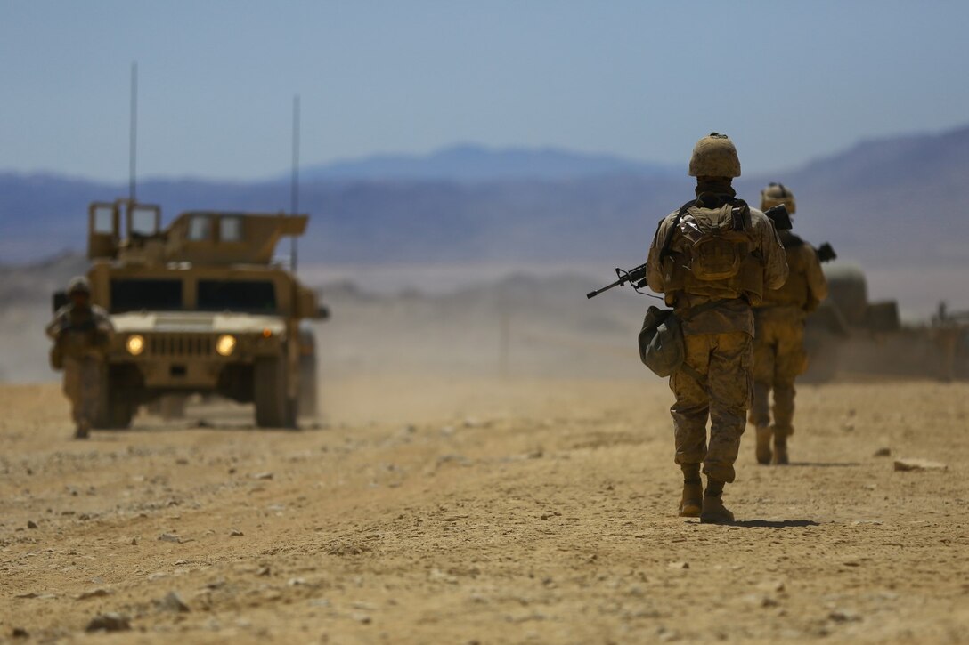 Marines with Headquarters Battalion, 1st Marine Division, conduct a security patrol during Exercise Desert Scimitar at Marine Corps Air Ground Combat Center Twentynine Palms, Calif., May 12, 2014. It is not uncommon for Marines from different jobs to be called upon to maintain security during field training. 1st Marine Division acts as the headquarters element of I Marine Expeditionary Force during the exercise.
