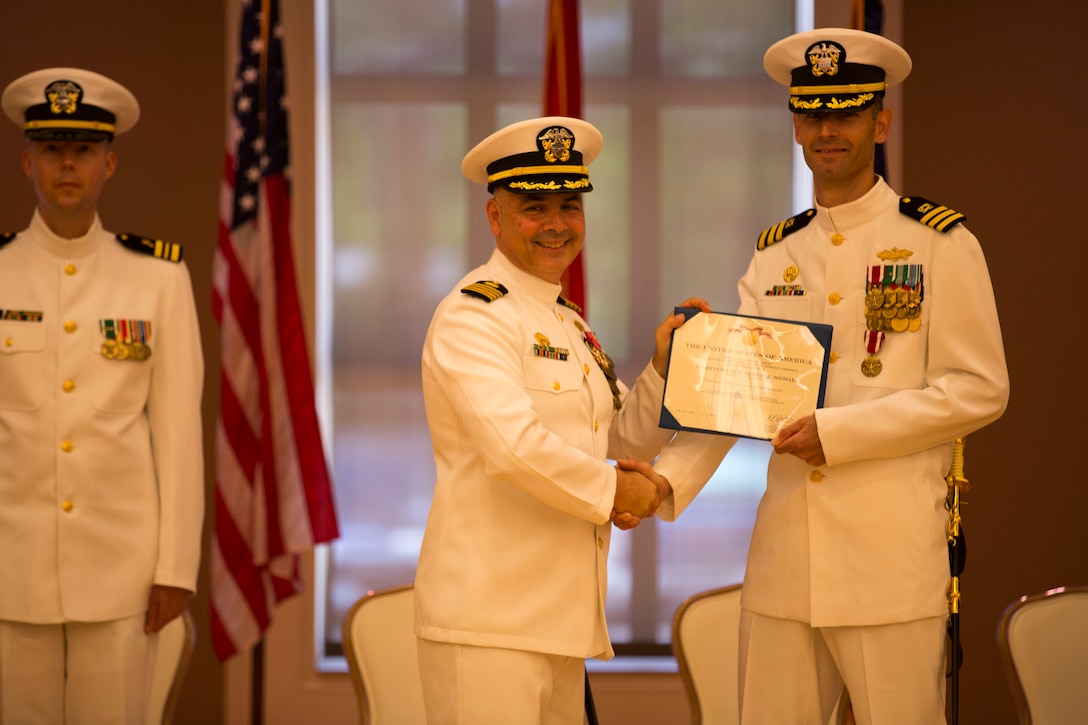 Cmdr. Scott Cloyd, the outgoing officer in charge of construction, receives an award during the disestablishment ceremony of Marine Corps Installations East Officer in Charge of Construction office at the Marston Pavilion aboard Marine Corps Base Camp Lejeune, May 6. The OICC was a unique office created to manage a large influx in construction during the last six years. Cloyd has led the OICC for the last two years.  