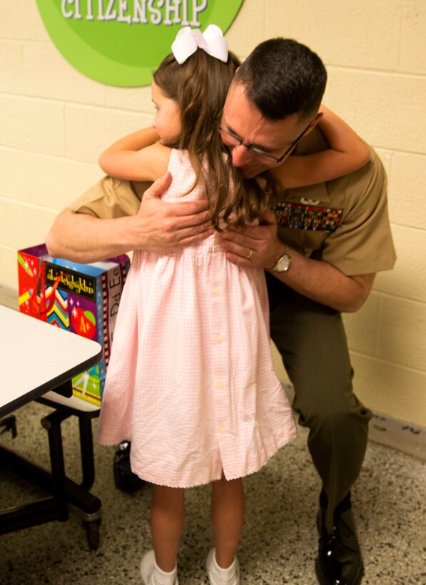 Brig. Gen. Robert Castellvi, the commanding general of Marine Corps Installations East – Marine Corps Base Camp Lejeune hugs Evoli, a military child, after meeting her for lunch at Parkwood Elementary School in Jacksonville, N.C, May 7. Evoli won the lunch with Castellvi at a raffle held during the All-American Family Night, an event hosted by the Camp Lejeune School Liaison in April.