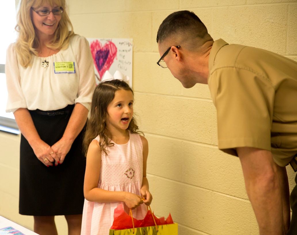 Brig. Gen. Robert Castellvi, the commanding general of Marine Corps Installations East – Marine Corps Base Camp Lejeune listens to Evoli, a military child, at Parkwood Elementary School in Jacksonville, N.C, May 7. Evoli won a lunch with Castellvi at a raffle held during the All-American Family Night, an event hosted by the Camp Lejeune School Liaison in April.