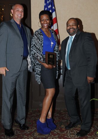 Sgt. Stephanie Bowens, noncommissioned officer-in-charge, Official Mailroom, Marine Corps Logistics Base Albany (center), receives the 2014 40 under 40 Award from Chris Hardy, president and CEO of the Albany Area Chamber of Commerce (left), and Ken Boler, general sales manager, The Albany Herald, following the May 1 ceremony held at Stonebridge Golf and Country Club in Albany, Ga.