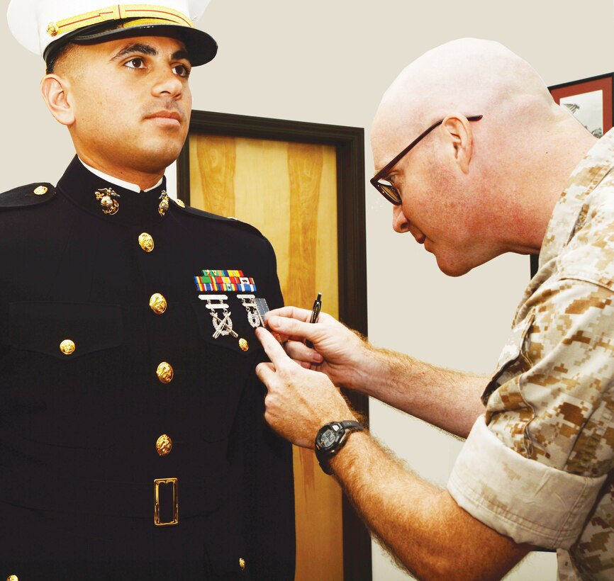 Lt. Col. Daniel Bates, executive officer, Marine Corps Logistics Base Albany, performs a uniform inspection of Capt. Marc Blair, deputy operations officer, MCLB Albany, as part of the inspector general program inspection, May 9.