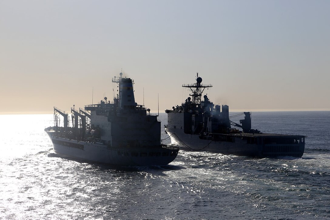 Military Sealift Command fleet replenishment oiler USNS Yukon, left, refuels the USS Comstock with, right, as part of an underway replenishment exercise conducted during Composite Training Unit Exercise (COMPTUEX) off the coast of San Diego, May 12, 2014. COMPTUEX serves as the second at-sea period for the 11th Marine Expeditionary Unit, in which the unit will focus on the enabling and supporting functions necessary for success during full mission profile operations on the upcoming deployment. (U.S. Marine Corps photo by Gunnery Sgt. Rome M. Lazarus/Released)