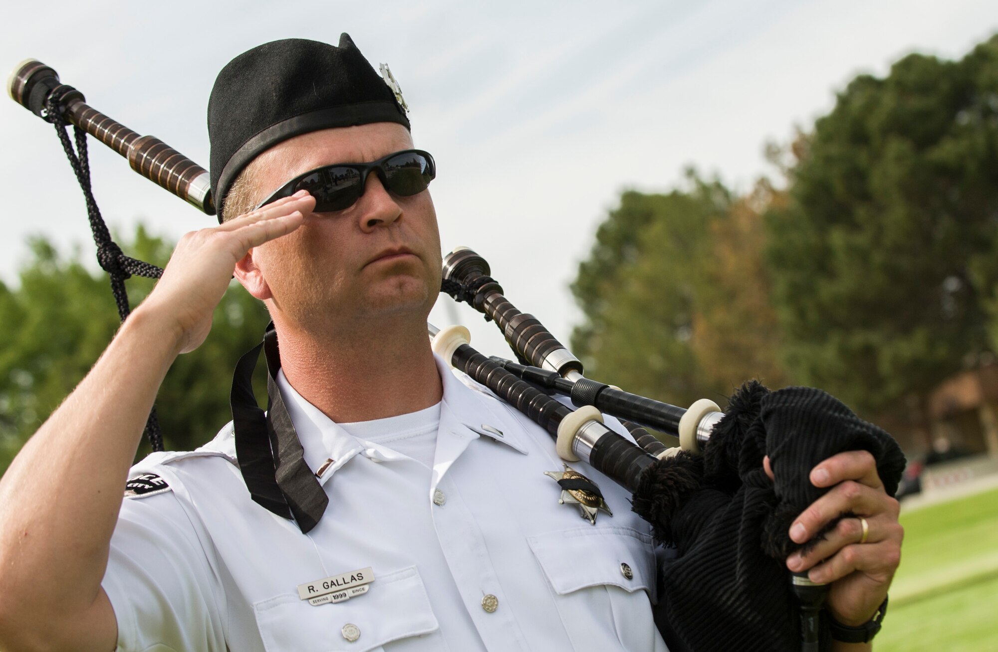 Lieutenant Rob Gallas, Boise Police Department community outreach, salutes during Peace Officers Memorial Day retreat ceremony at Mountain Home Air Force Base, Idaho, May 15, 2014. Gallas played “Amazing Grace” on bagpipes for a wreath-laying during the ceremony. Federal, state and local police agencies across the nation now participate in this annual event to honor their fallen comrades and take a momentary pause to remember the sacrifices our law enforcement and police professionals make each and every day. (U.S. Air Force photo by Staff Sgt. Roy Lynch III/RELEASED)