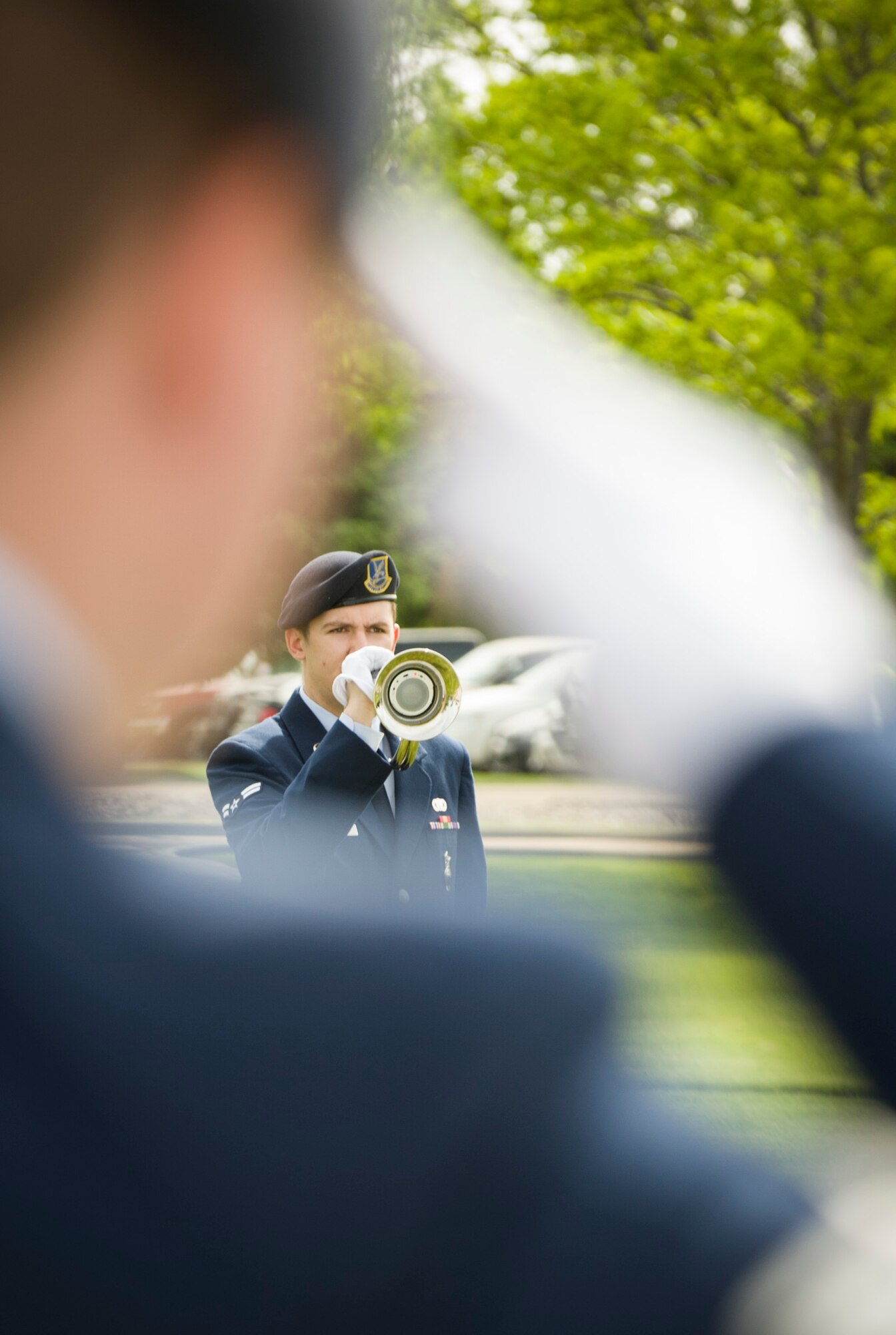 An Airman salutes during the playing of taps at Mountain Home Air Force Base, Idaho, May 15, 2014. The playing of taps was part of a Peace Officers Memorial Day retreat ceremony honoring law enforcement officers who have given everything for the service of their country. (U.S. Air Force photo by Staff Sgt. Roy Lynch III/RELEASED)
