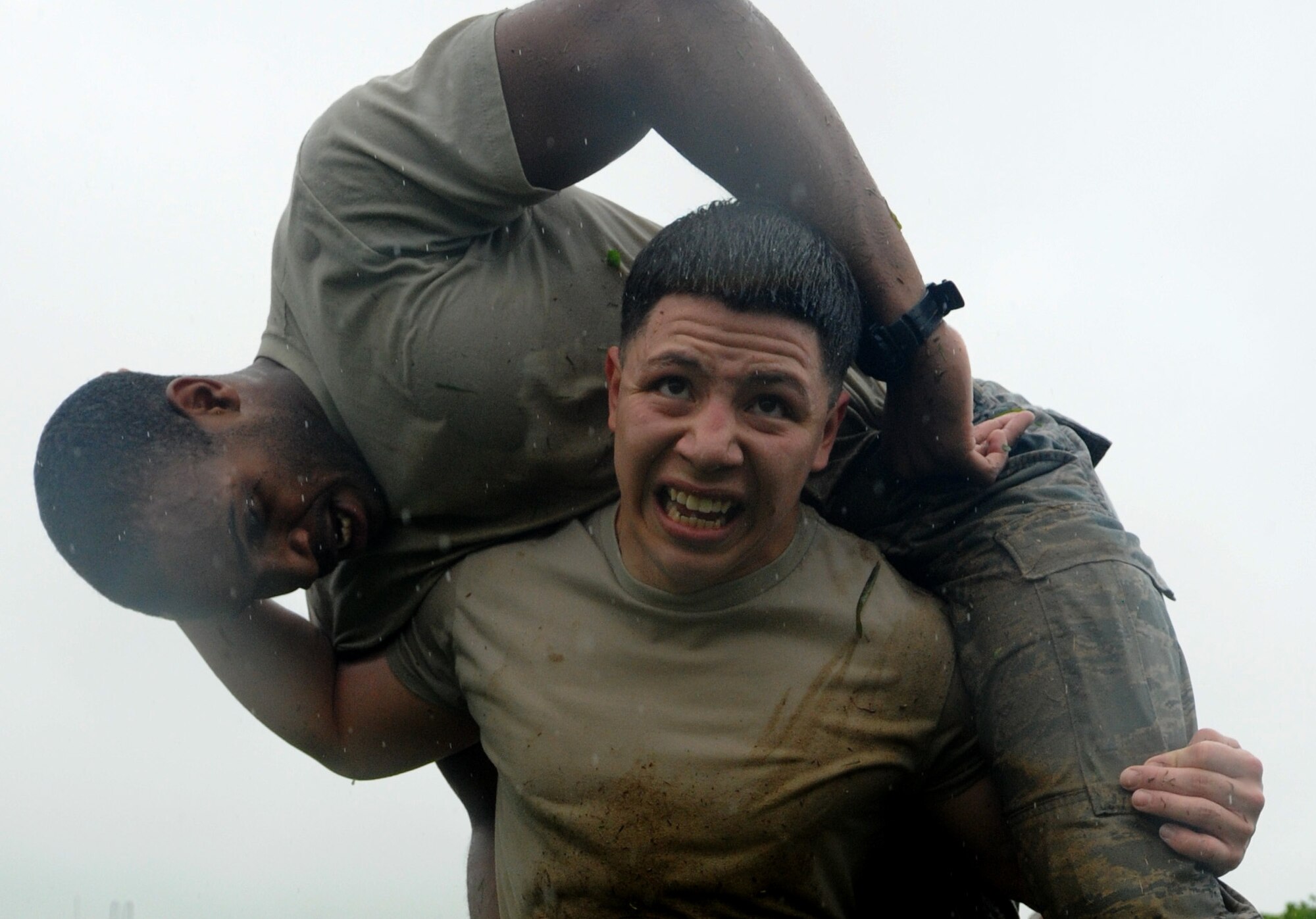 U.S. Air Force Airman 1st Class Gerardo Romo, 18th Logistics Readiness Squadron storage and issue journeymen, fireman squats Airman 1st Class Jared Utsey, 18th Logistics Readiness Squadron south side aircraft part store apprentice, during the Defenders Challenge on Kadena Air Base, Japan, May 13, 2014. The Defenders Challenge was only a portion of the 2014 National Police Week that included events such as a 24-hour vigil run, jail and bail fundraiser and a memorial to honor fallen military police members worldwide. (U.S. Air Force photo by Airman 1st Class Keith James)