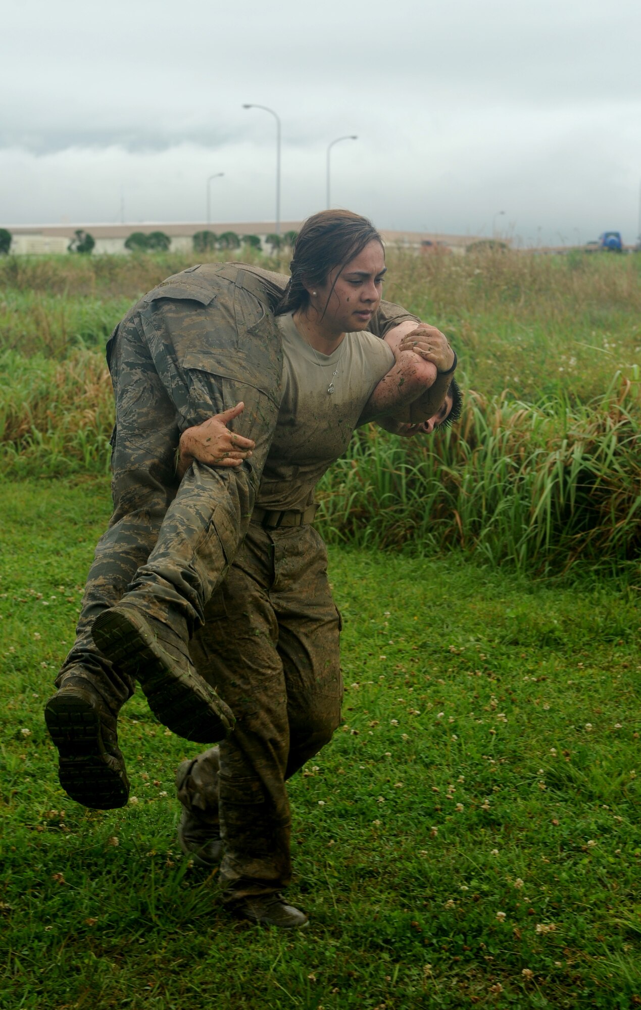 U.S. Air Force Staff Sgt. Lorri Lyons, 18th Security Forces Squadron response force leader, fireman carries a teammate during the Defenders Challenge on Kadena Air Base, Japan, May 13, 2014. The Defenders Challenge was only a portion of the 2014 National Police Week that included events such as a 24-hour vigil run, jail and bail fundraiser and a memorial to honor fallen military police members worldwide.(U.S. Air Force photo by Airman 1st Class Keith James)