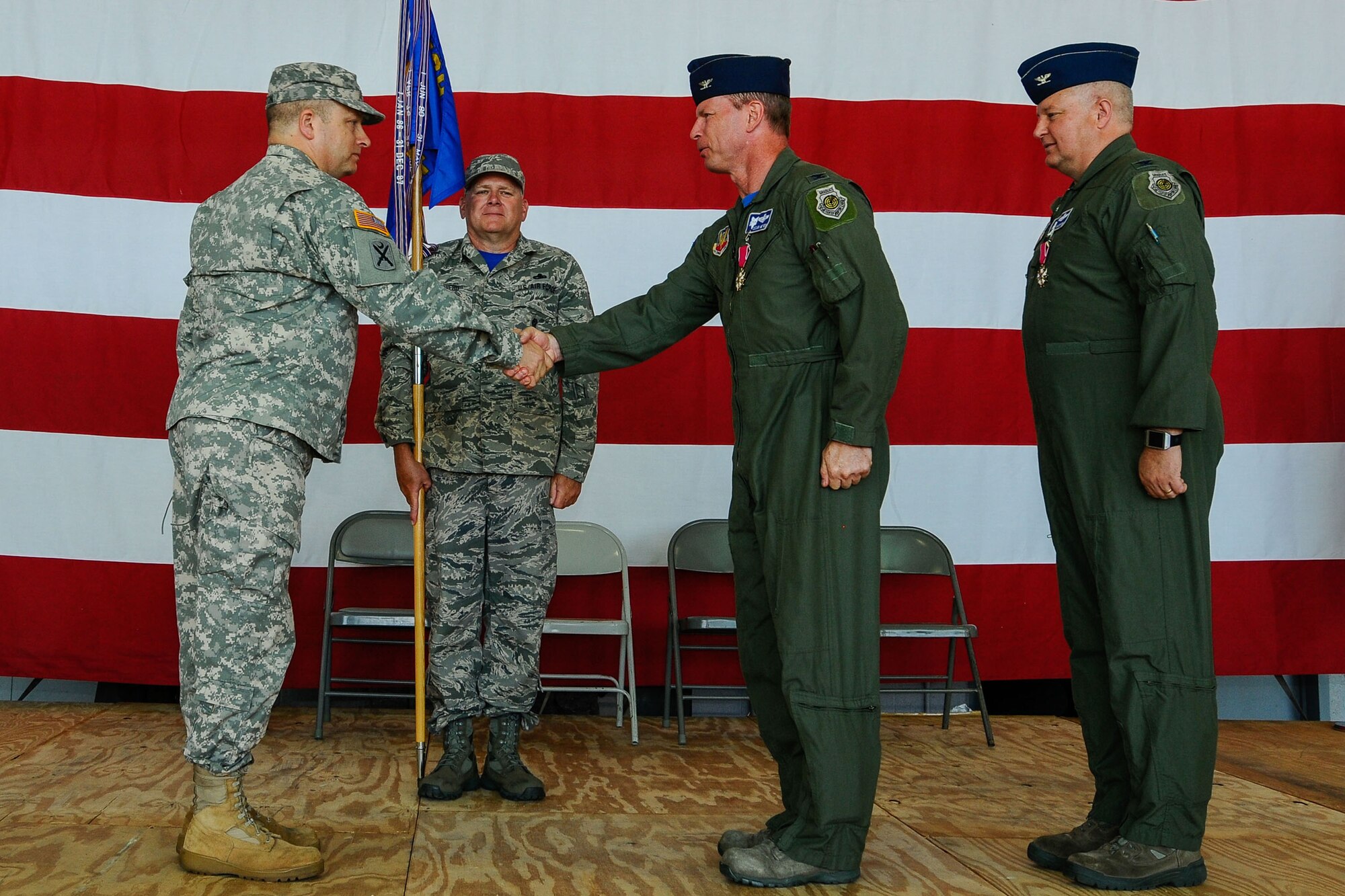 U.S. Army Maj. Gen. Robert E. Livingston Jr., The Adjutant General of South Carolina, congratulates Col. David Meyer, the new commander of the 169th Fighter Wing. U.S. Airmen of the 169th Fighter Wing and the South Carolina Air National Guard, assemble for a change of command ceremony at McEntire Joint National Guard Base, S.C., May 3, 2014. Col. Michael Manning relinquishes command of the wing to Col. David Meyer. (U.S. Air National Guard photo by Tech. Sgt. Jorge Intriago/Released)